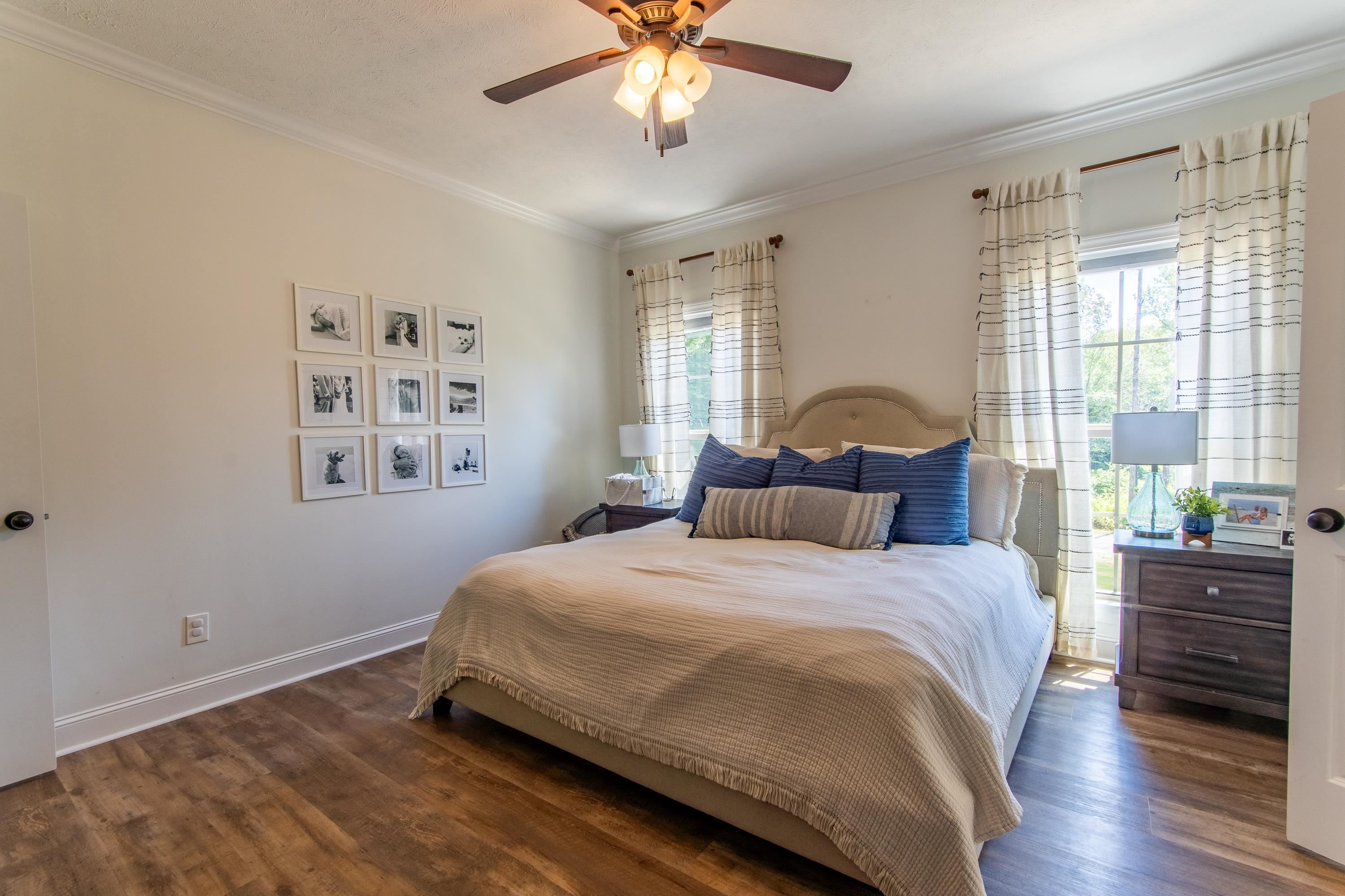 Bedroom featuring crown molding, dark hardwood / wood-style floors, and ceiling fan