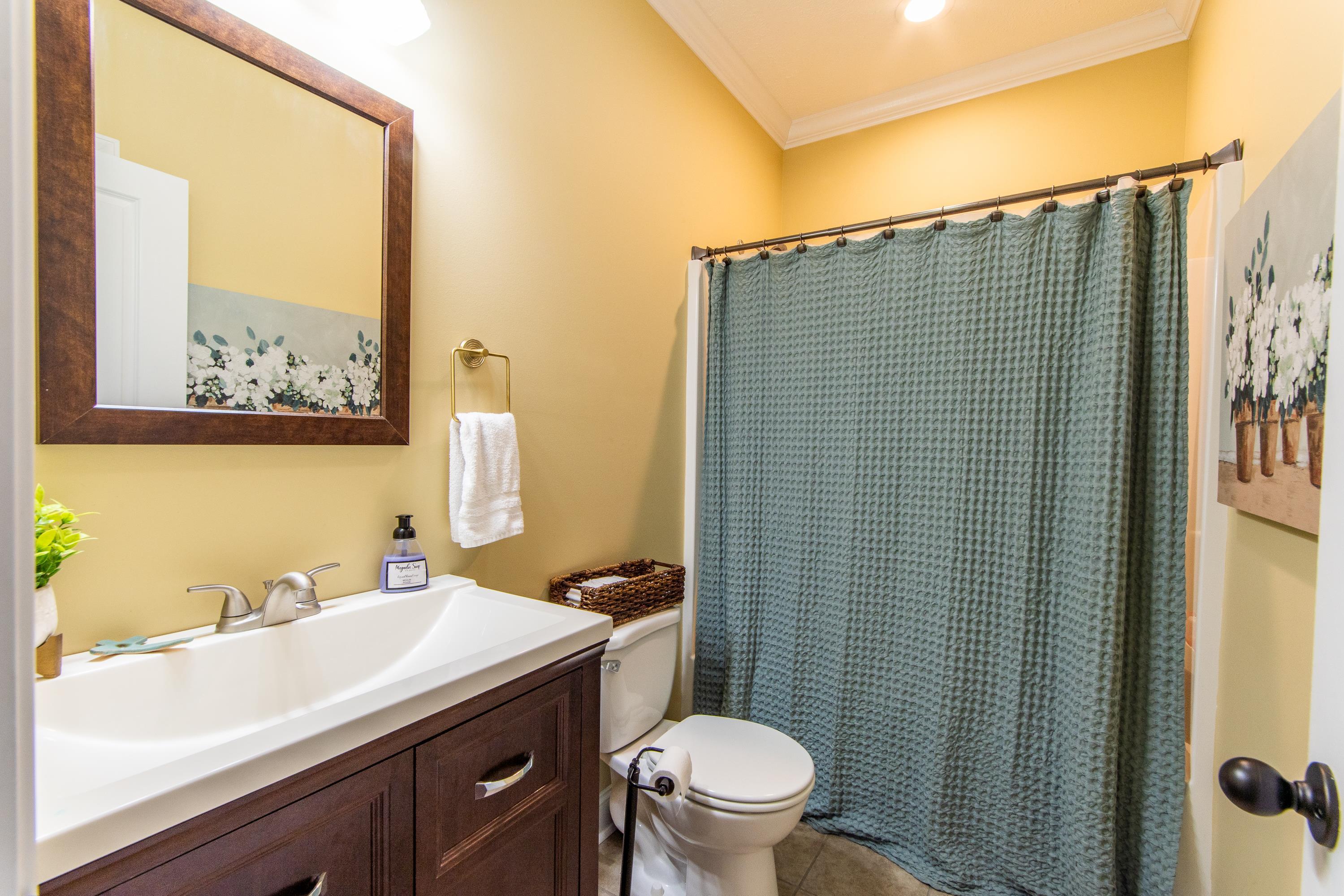 Bathroom with vanity, crown molding, tile patterned flooring, and toilet