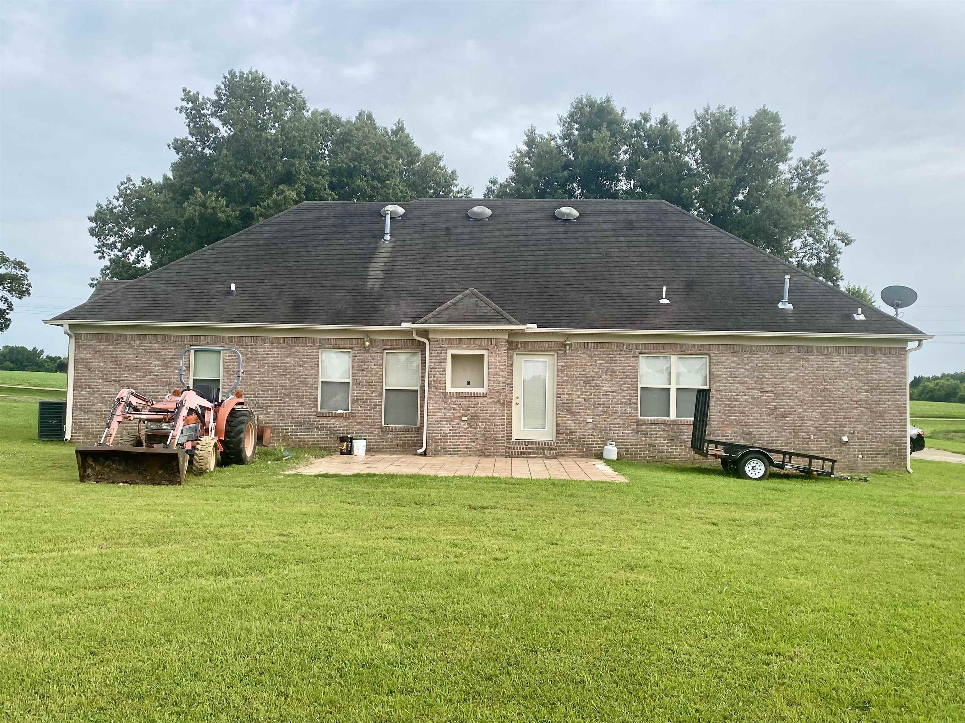 Rear view of property featuring a patio and a lawn