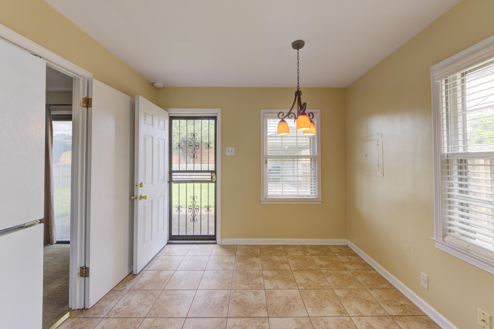 Eat-in Kitchen with door leading to backyard.