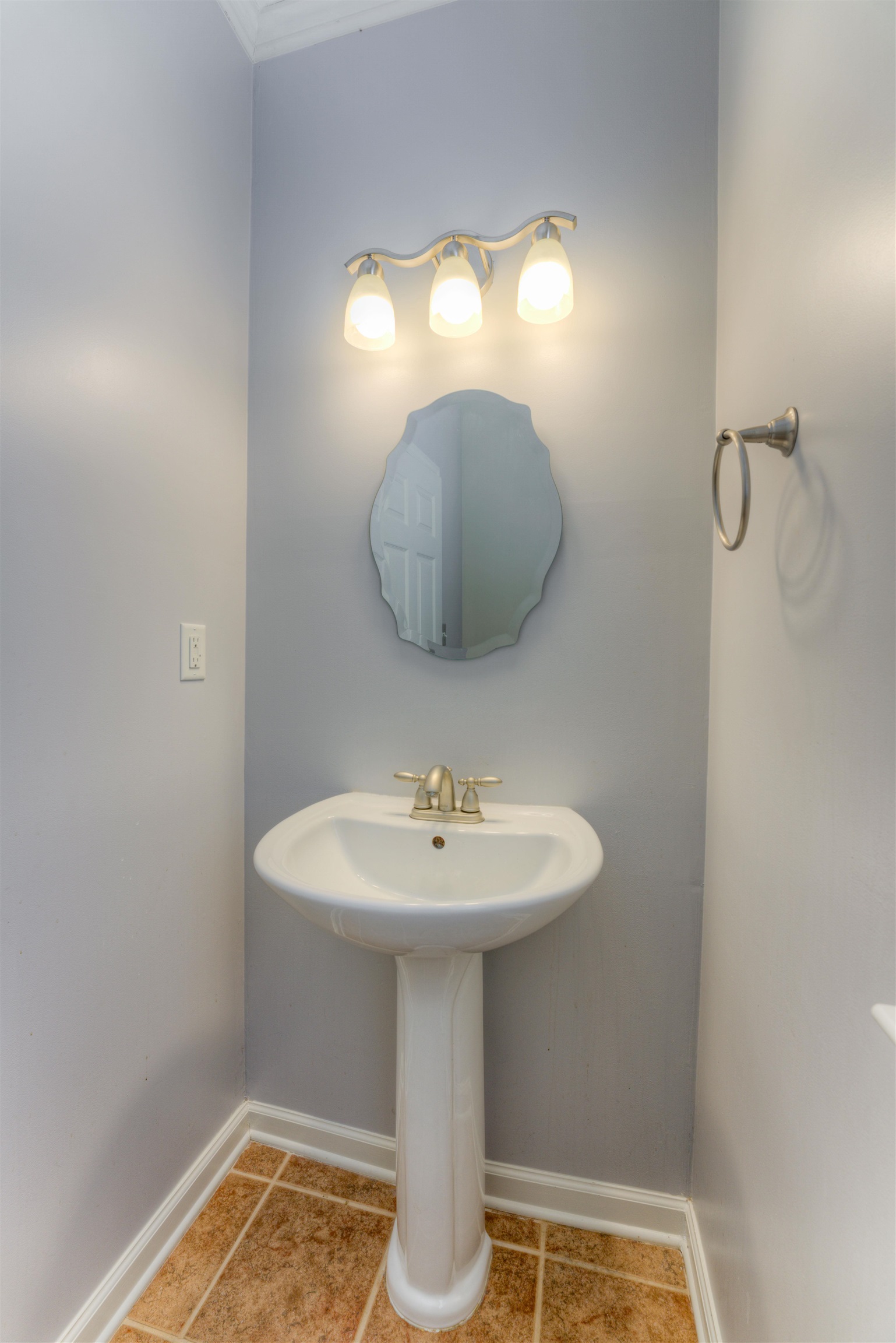 Bathroom with tile patterned flooring and crown molding