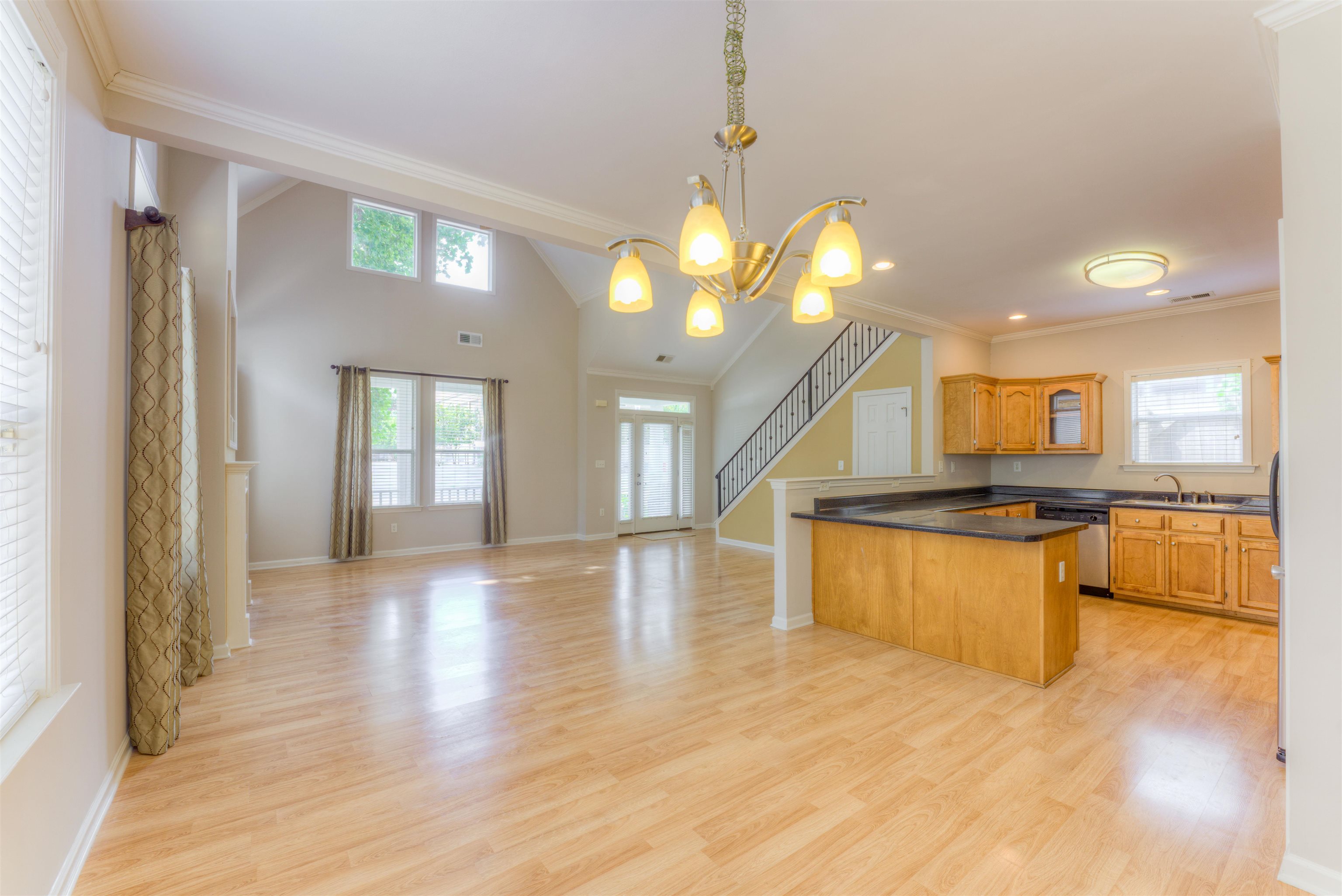 Kitchen featuring a chandelier, light wood-type flooring, ornamental molding, sink, and dishwasher