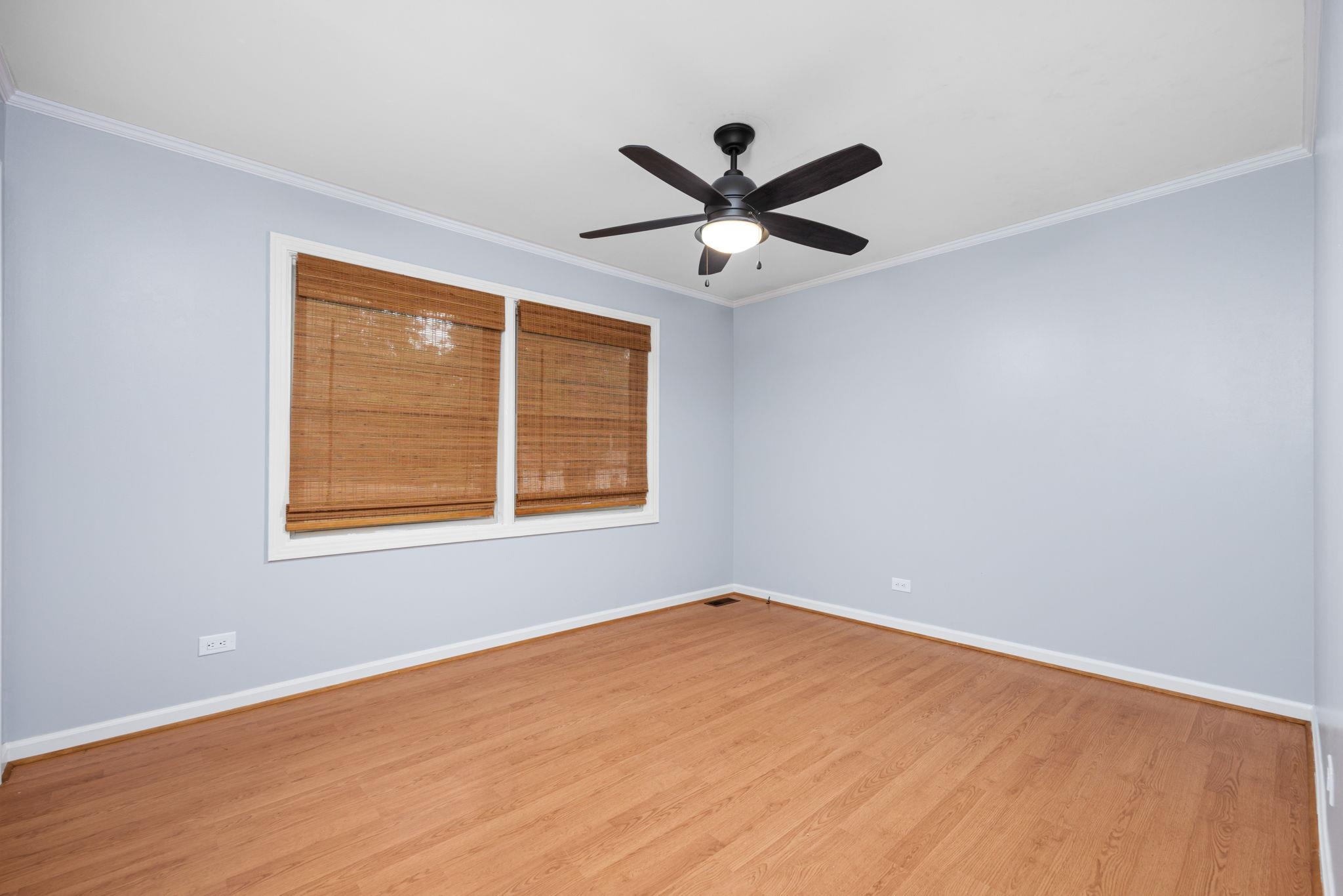 Unfurnished room with ceiling fan, crown molding, and hardwood / wood-style flooring