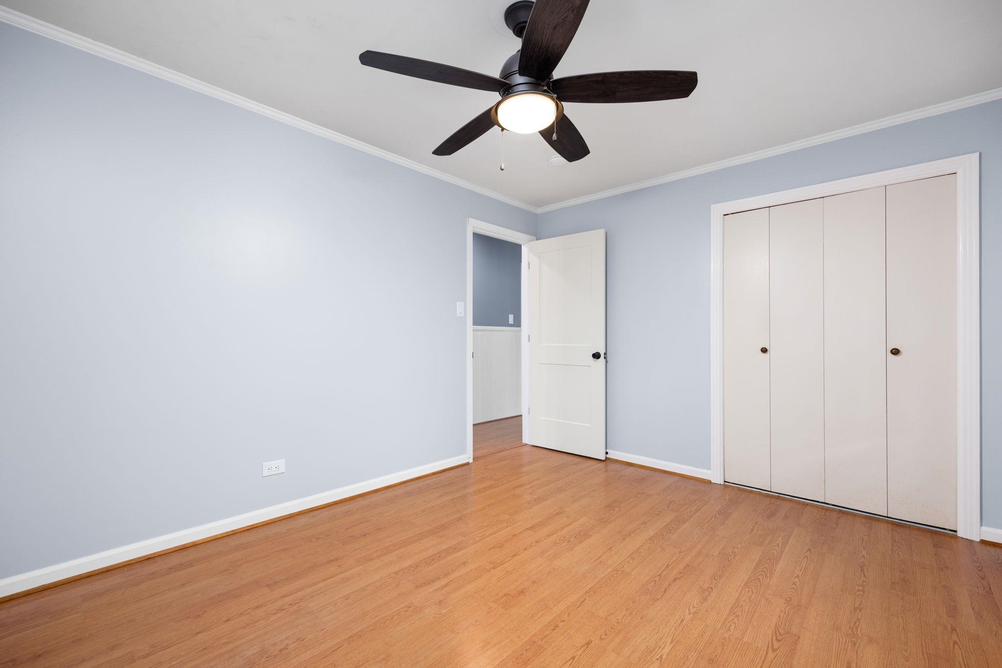 Unfurnished bedroom with light hardwood / wood-style floors, a closet, ceiling fan, and crown molding