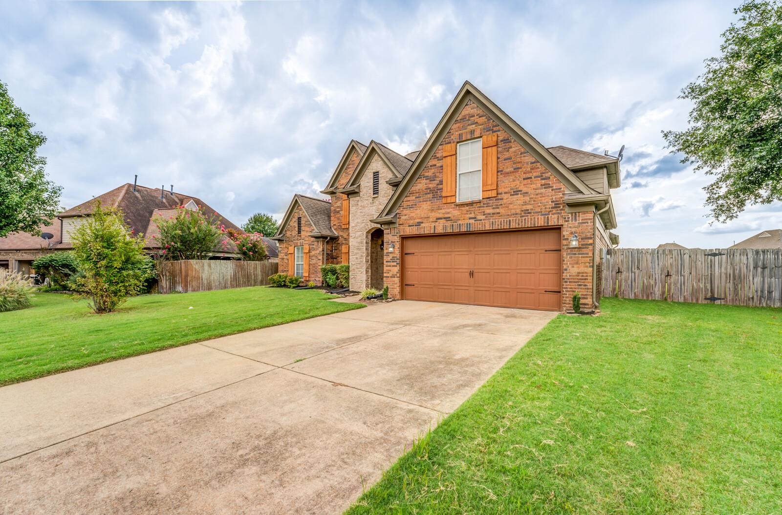 View of front of house with a garage and a front yard