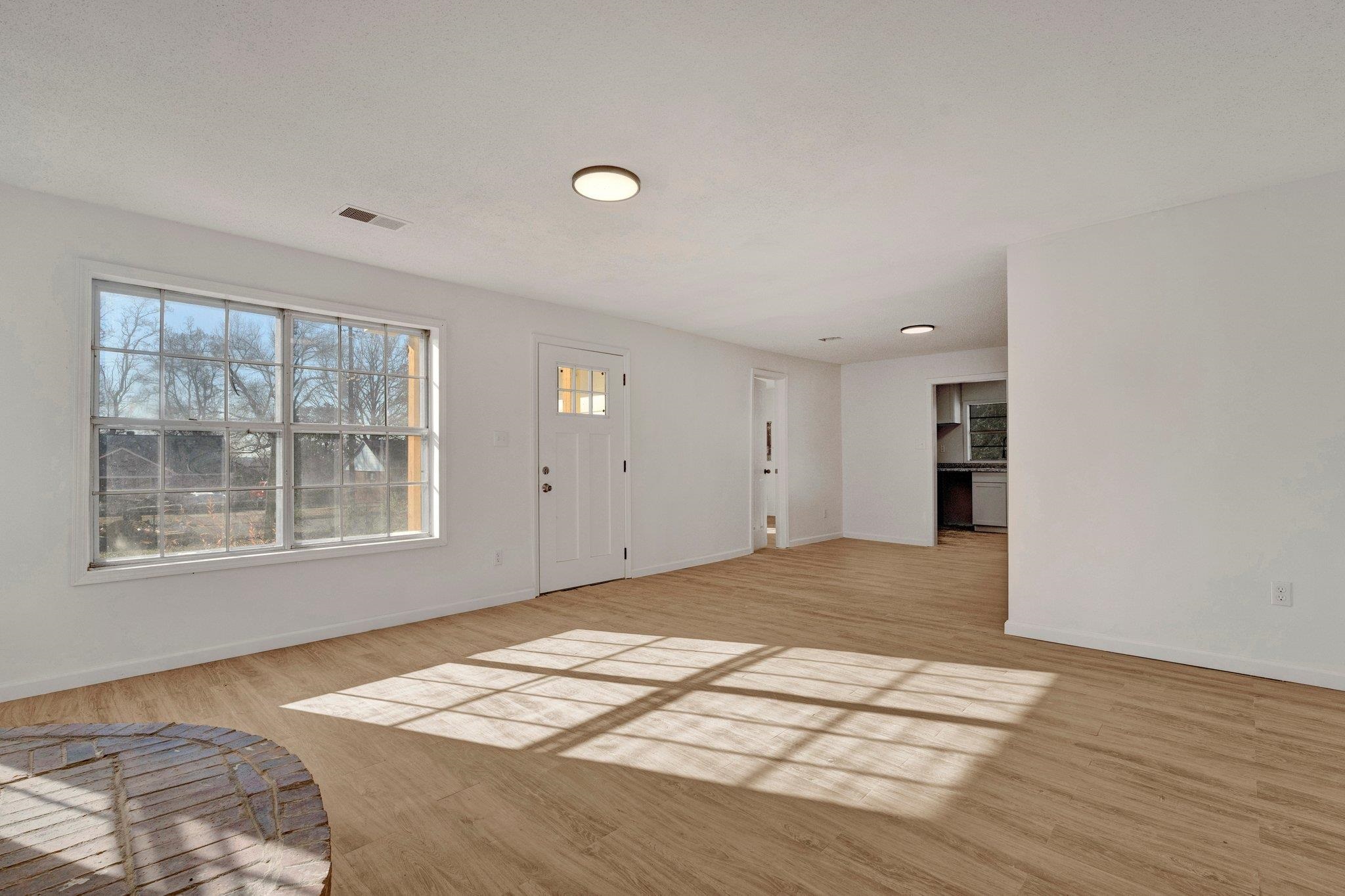 Entrance foyer with a wealth of natural light and light wood-type flooring