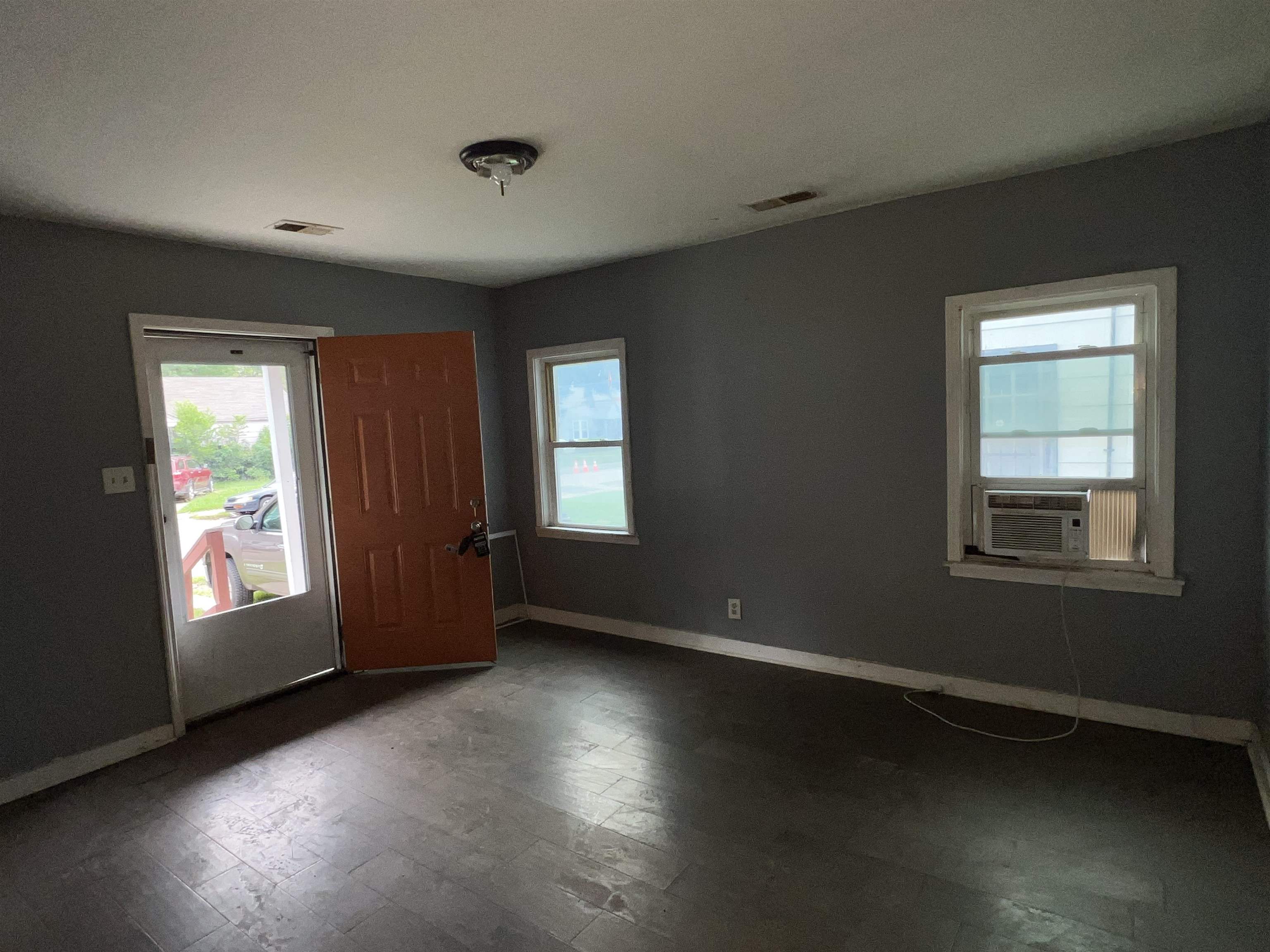 Spare room featuring wood-type flooring and cooling unit