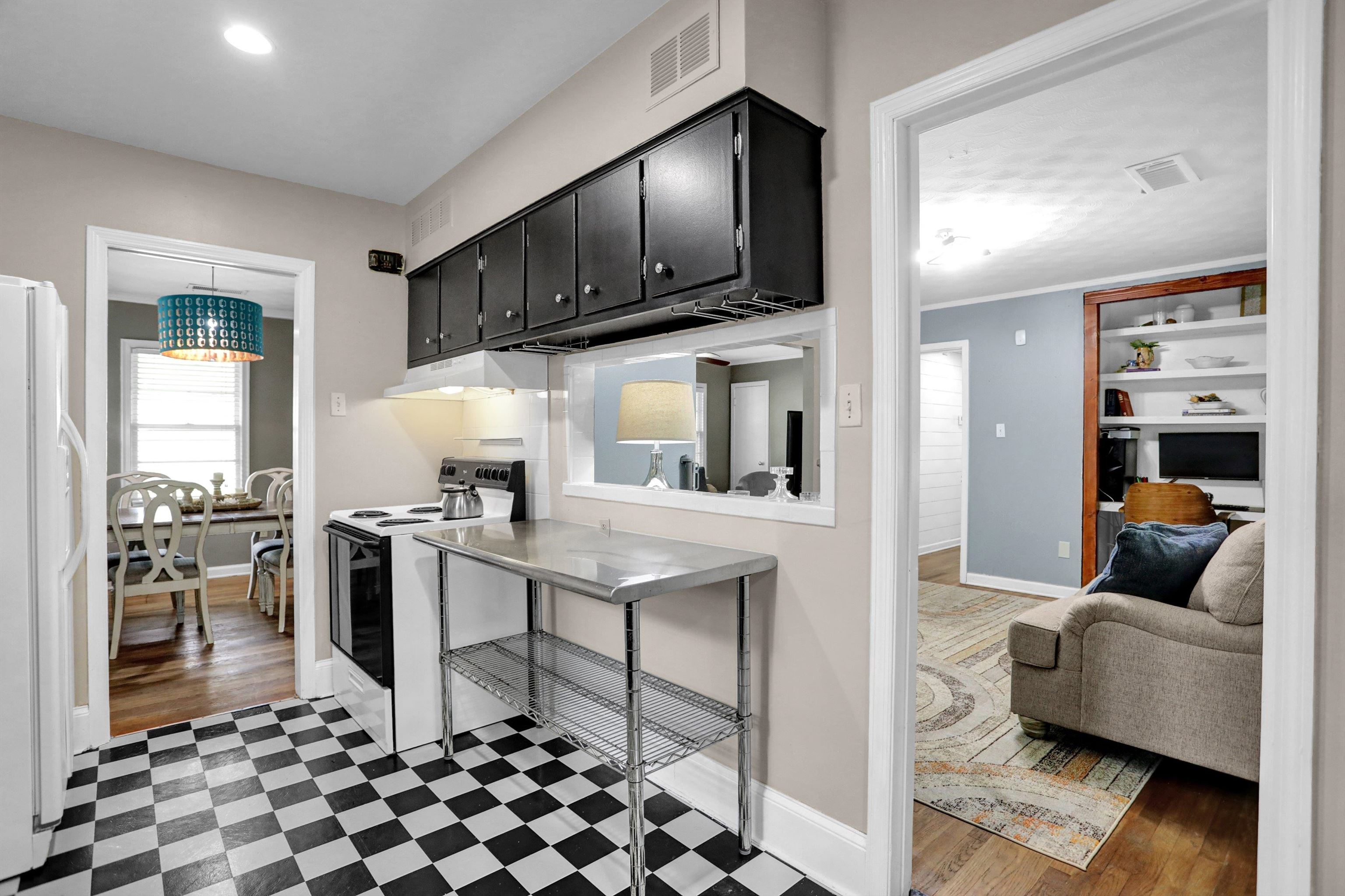 Kitchen with a chandelier, dark hardwood / wood-style flooring, white appliances, and range hood