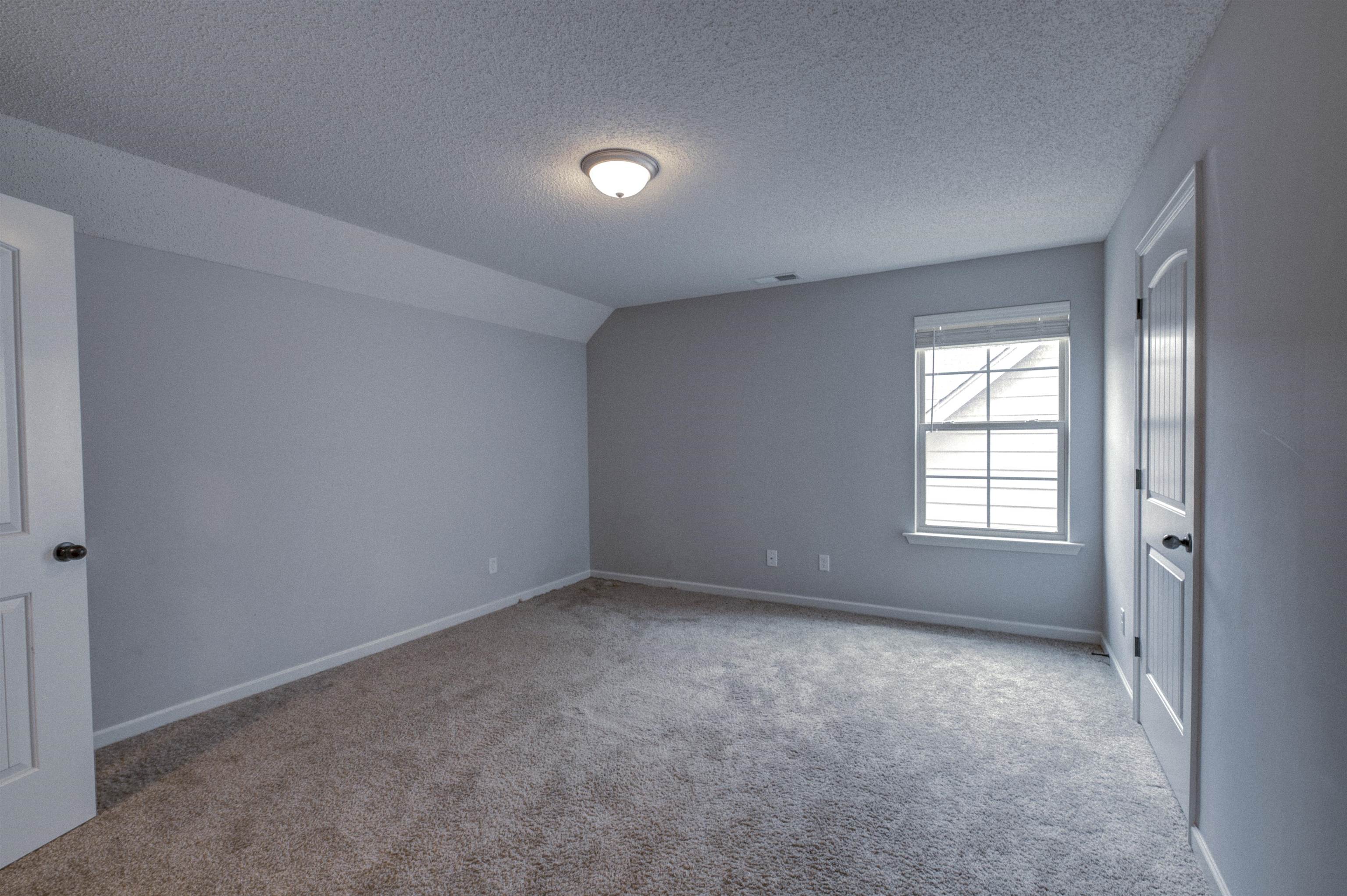 Spare room featuring carpet floors and a textured ceiling