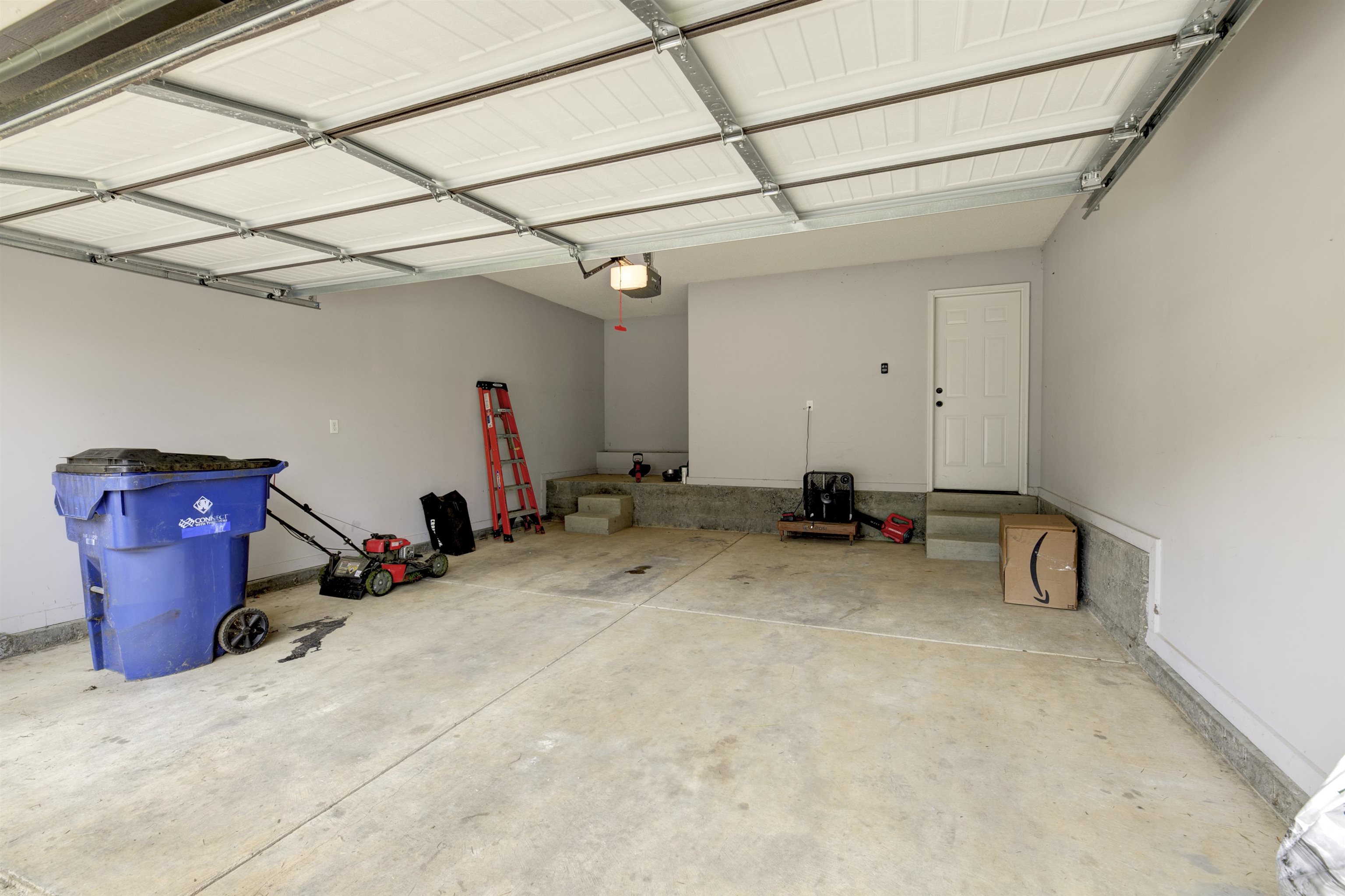 Garage featuring a garage door opener