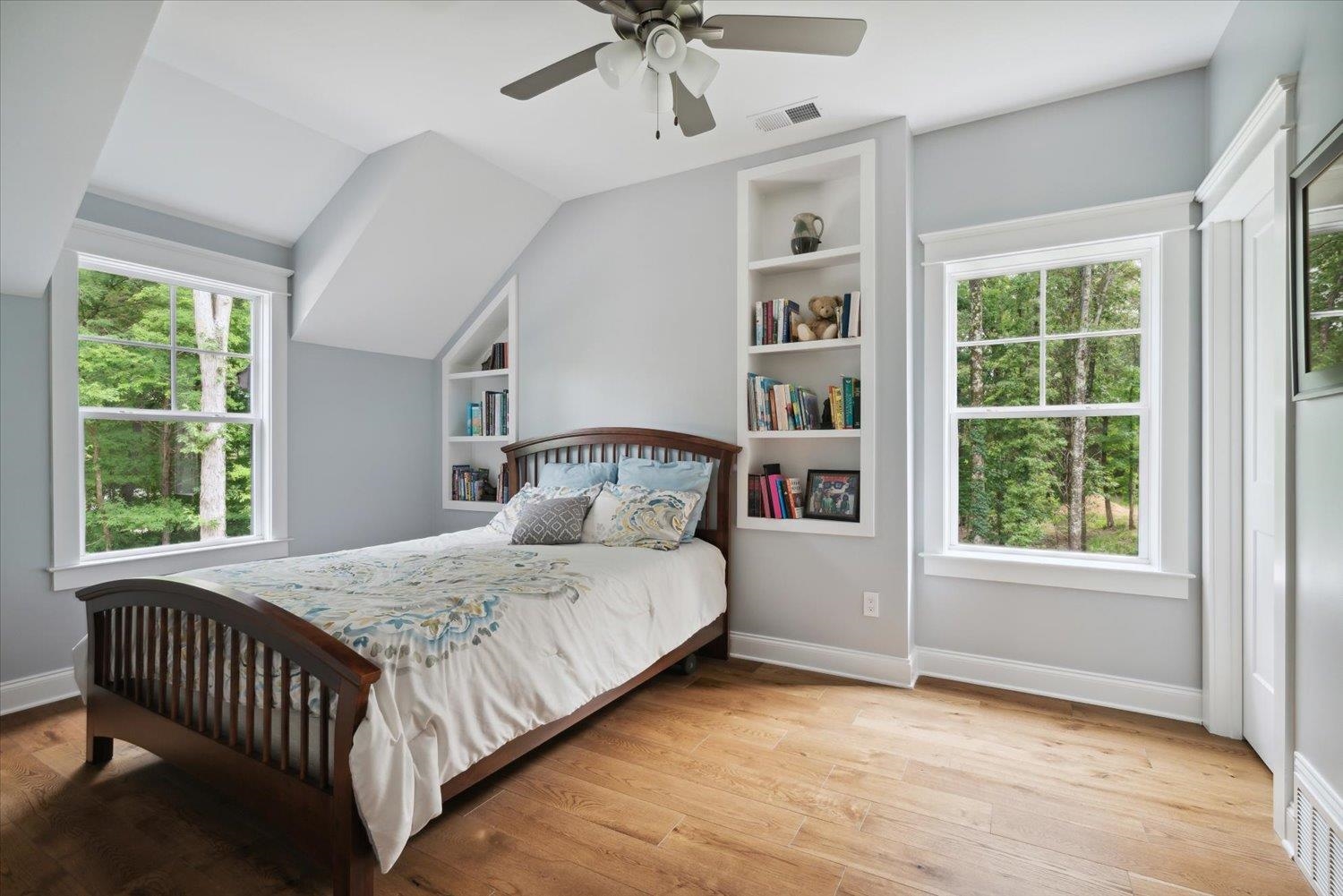 Bedroom with ceiling fan, light hardwood / wood-style flooring, and vaulted ceiling