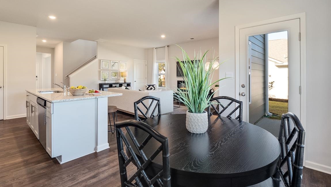 Dining room featuring sink and dark wood-type flooring