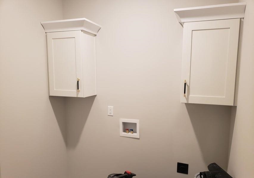 Washroom featuring cabinets, hookup for a washing machine, and electric dryer hookup