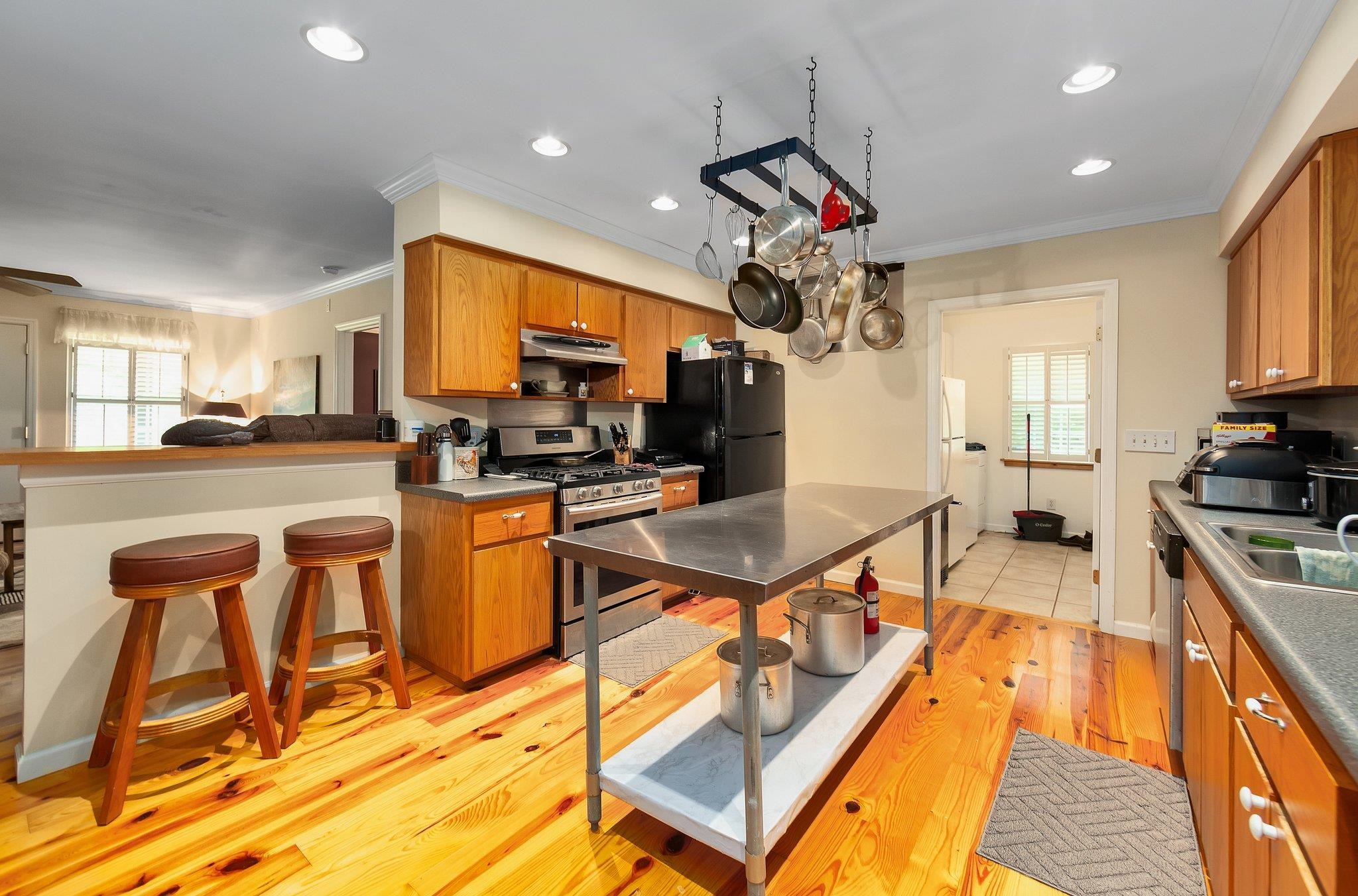 Kitchen featuring light hardwood / wood-style floors, a wealth of natural light, a breakfast bar area, and stainless steel appliances