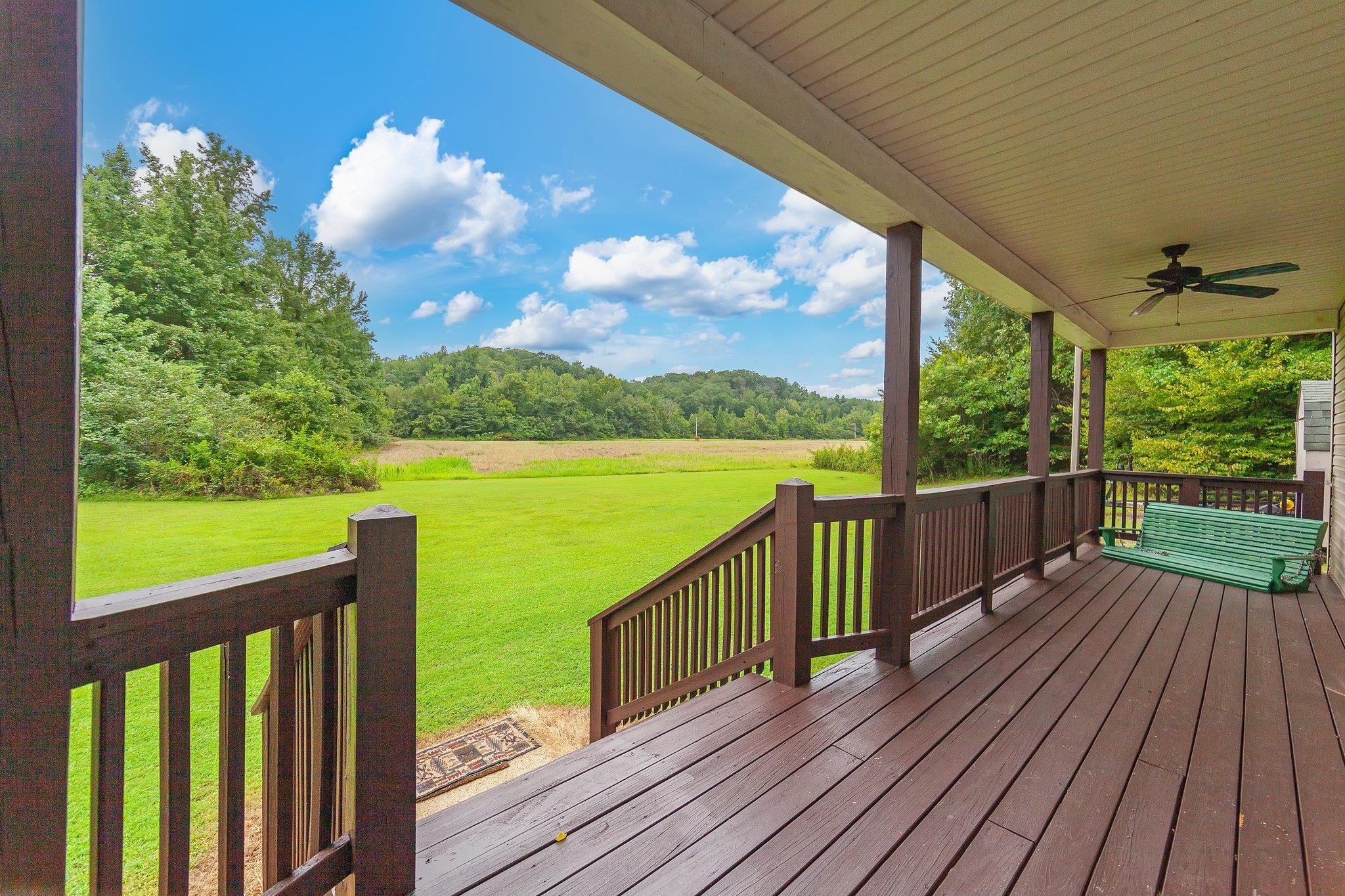 Deck featuring a yard and ceiling fan