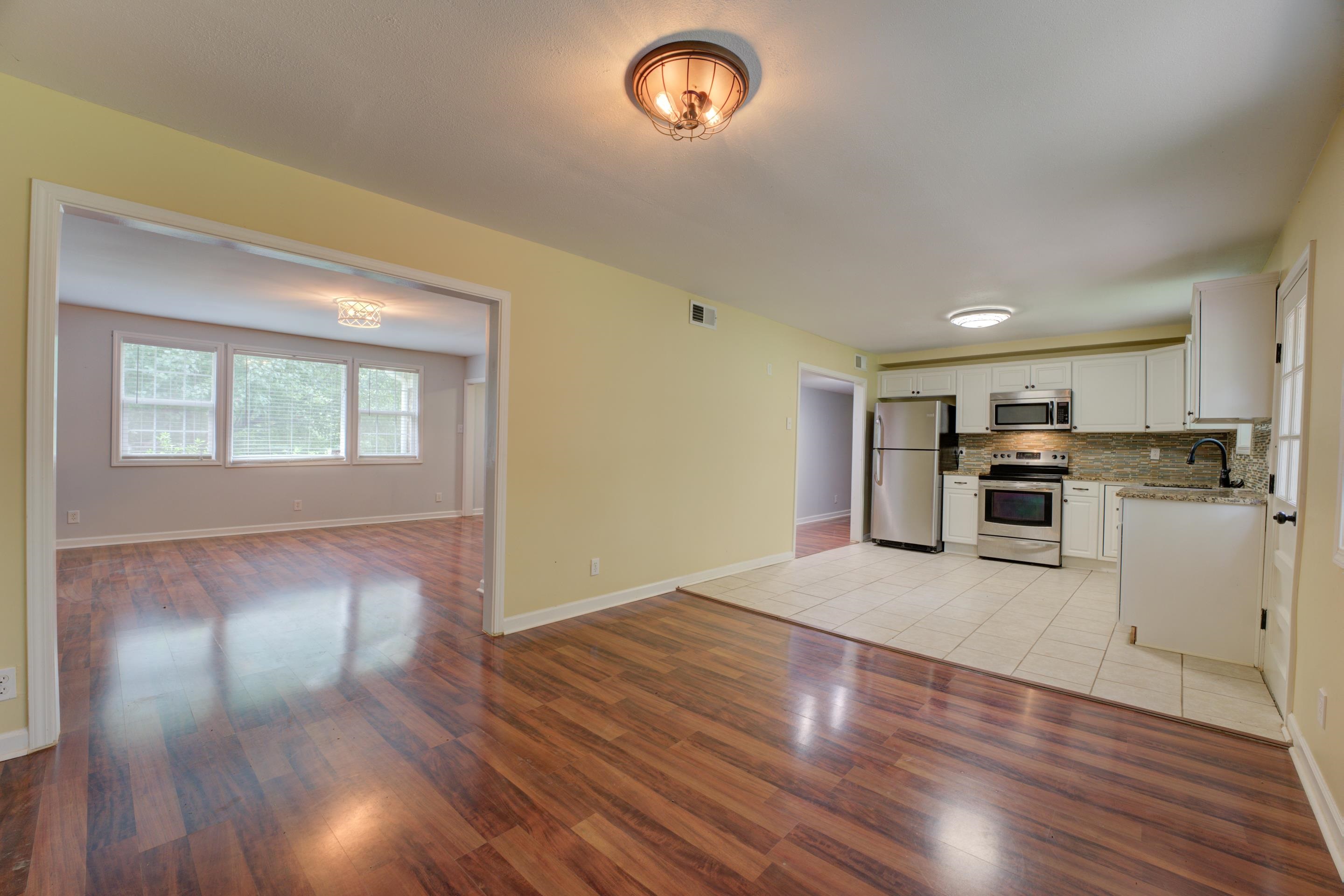 Kitchen featuring sink, appliances with stainless steel finishes, decorative backsplash, and light hardwood / wood-style floors