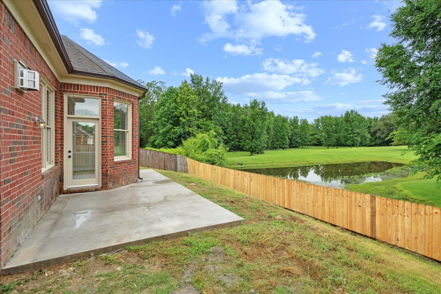 View of yard with a patio and a water view