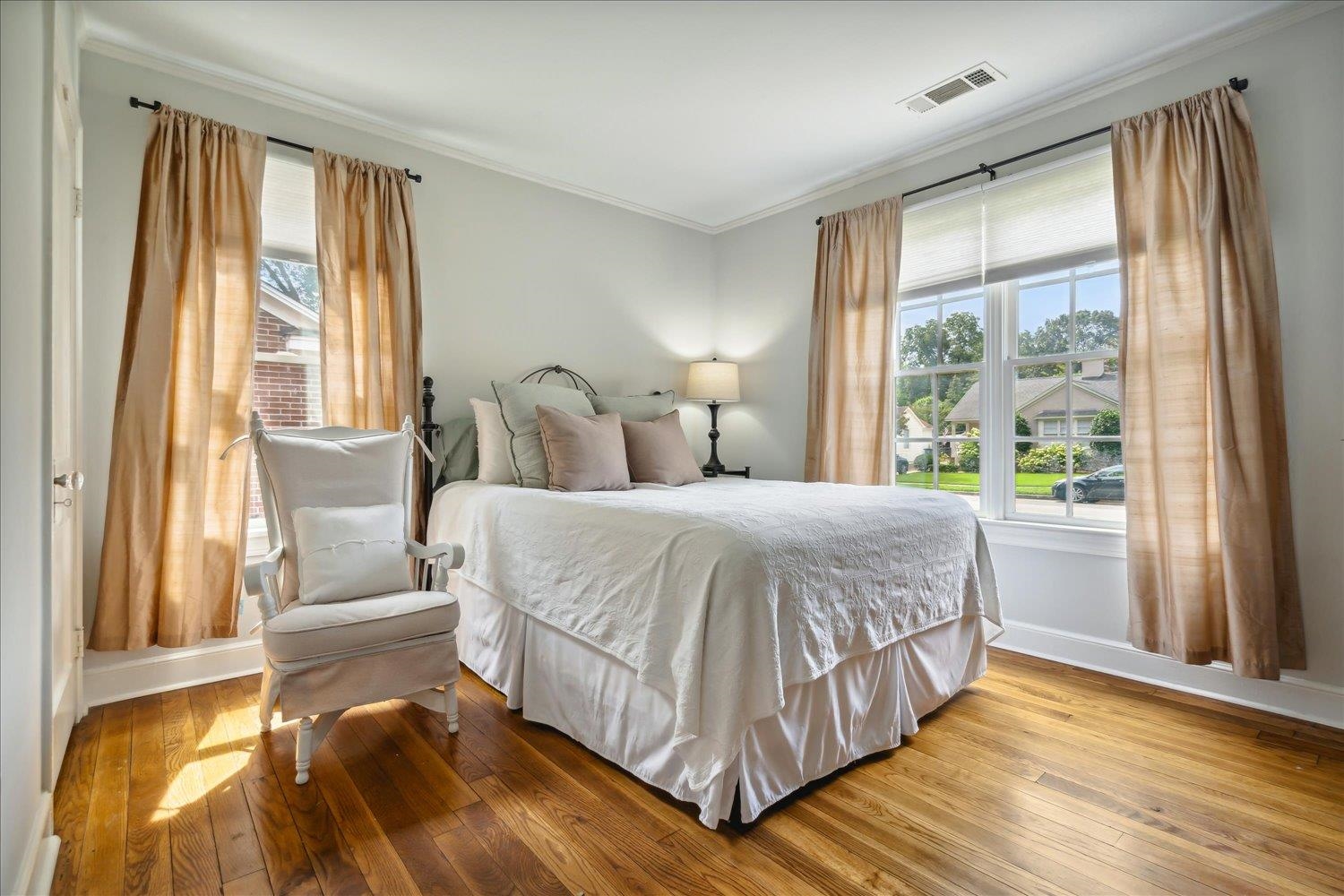 Bedroom featuring crown molding and light hardwood / wood-style flooring