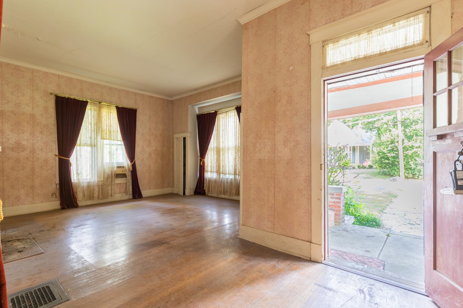 Entryway with hardwood / wood-style flooring and crown molding