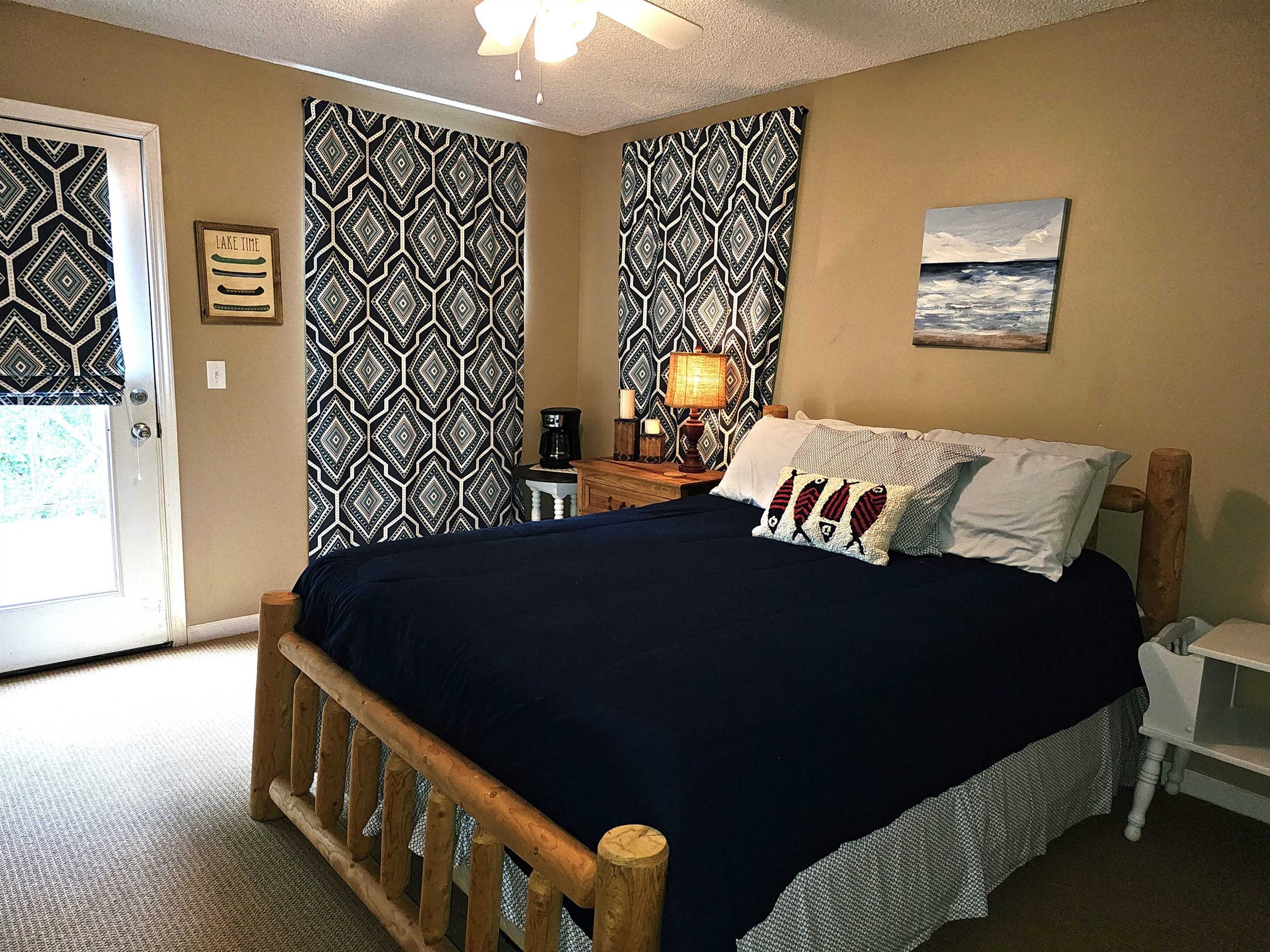 Carpeted bedroom featuring a textured ceiling and ceiling fan