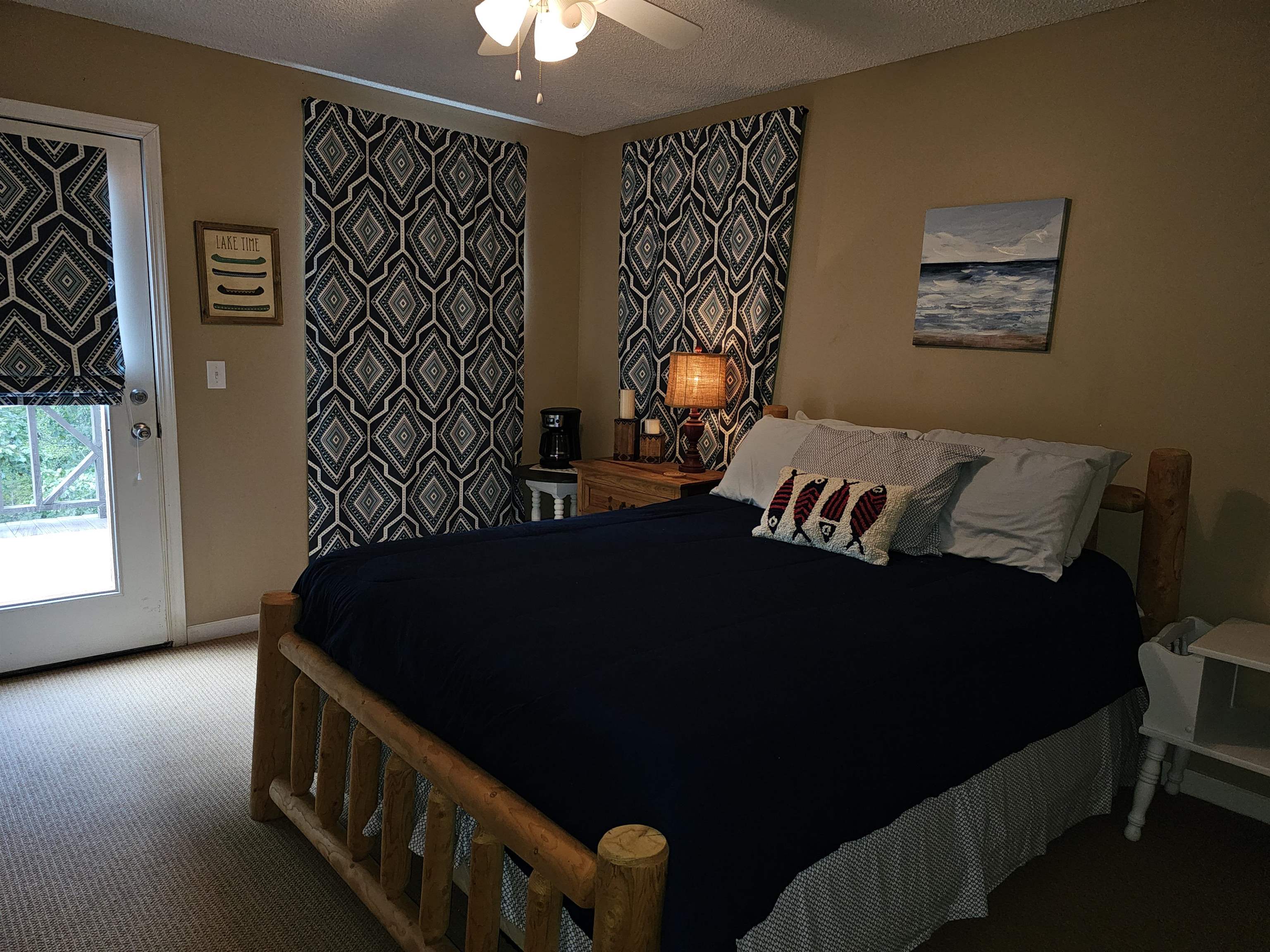 Bedroom featuring carpet floors, a textured ceiling, and ceiling fan