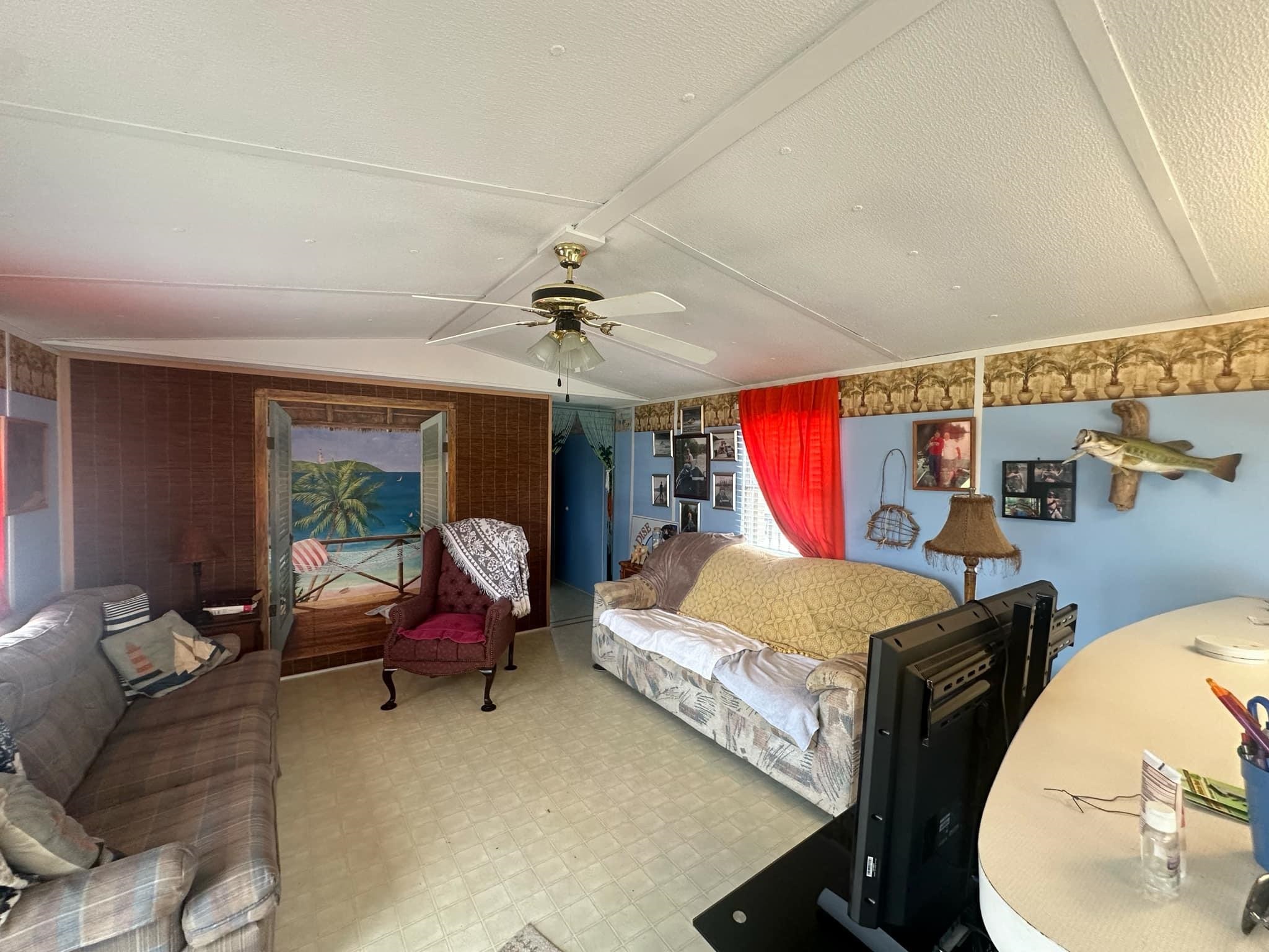 Bedroom with ceiling fan and vaulted ceiling