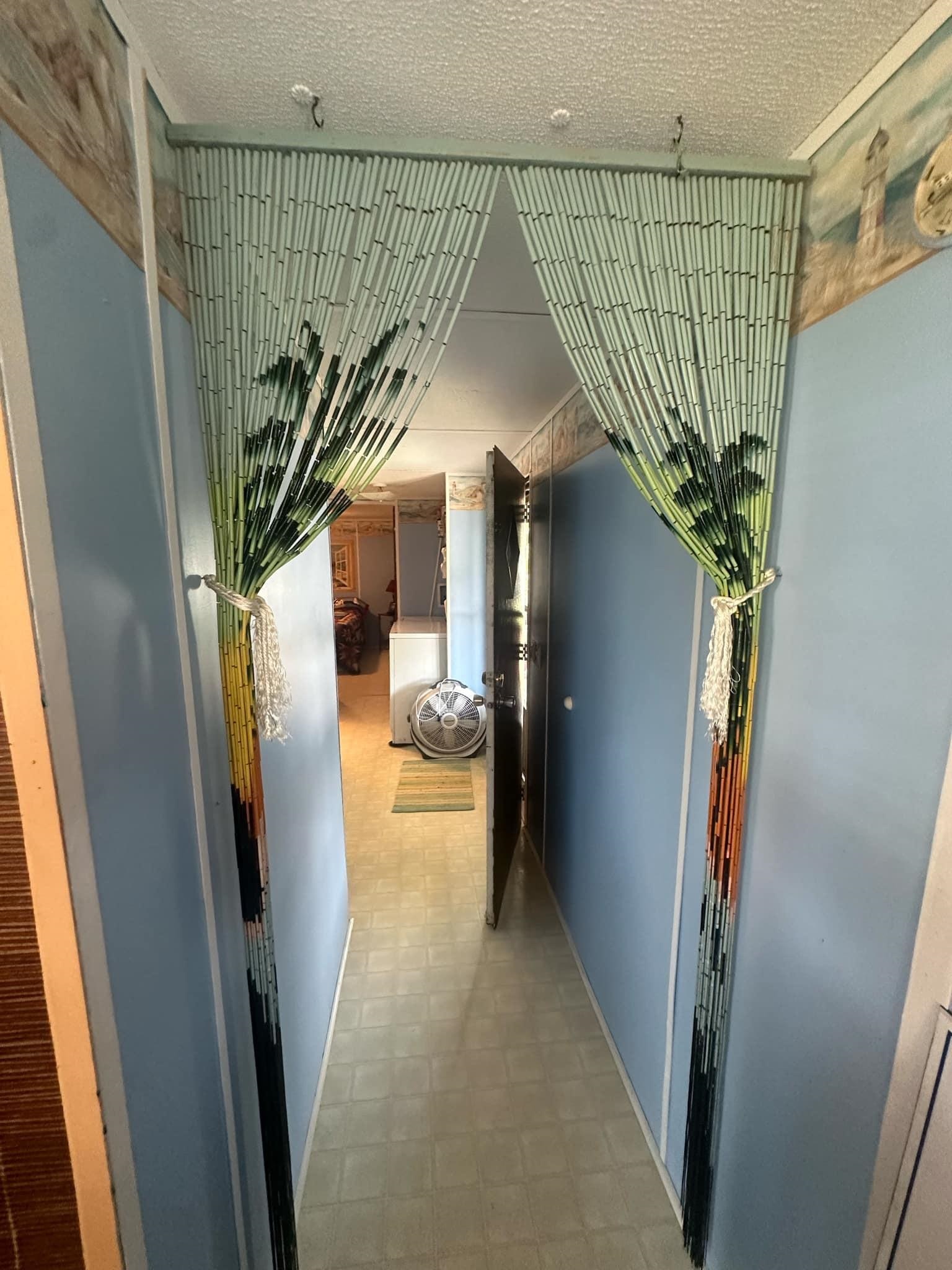 Corridor with tile patterned flooring and a textured ceiling