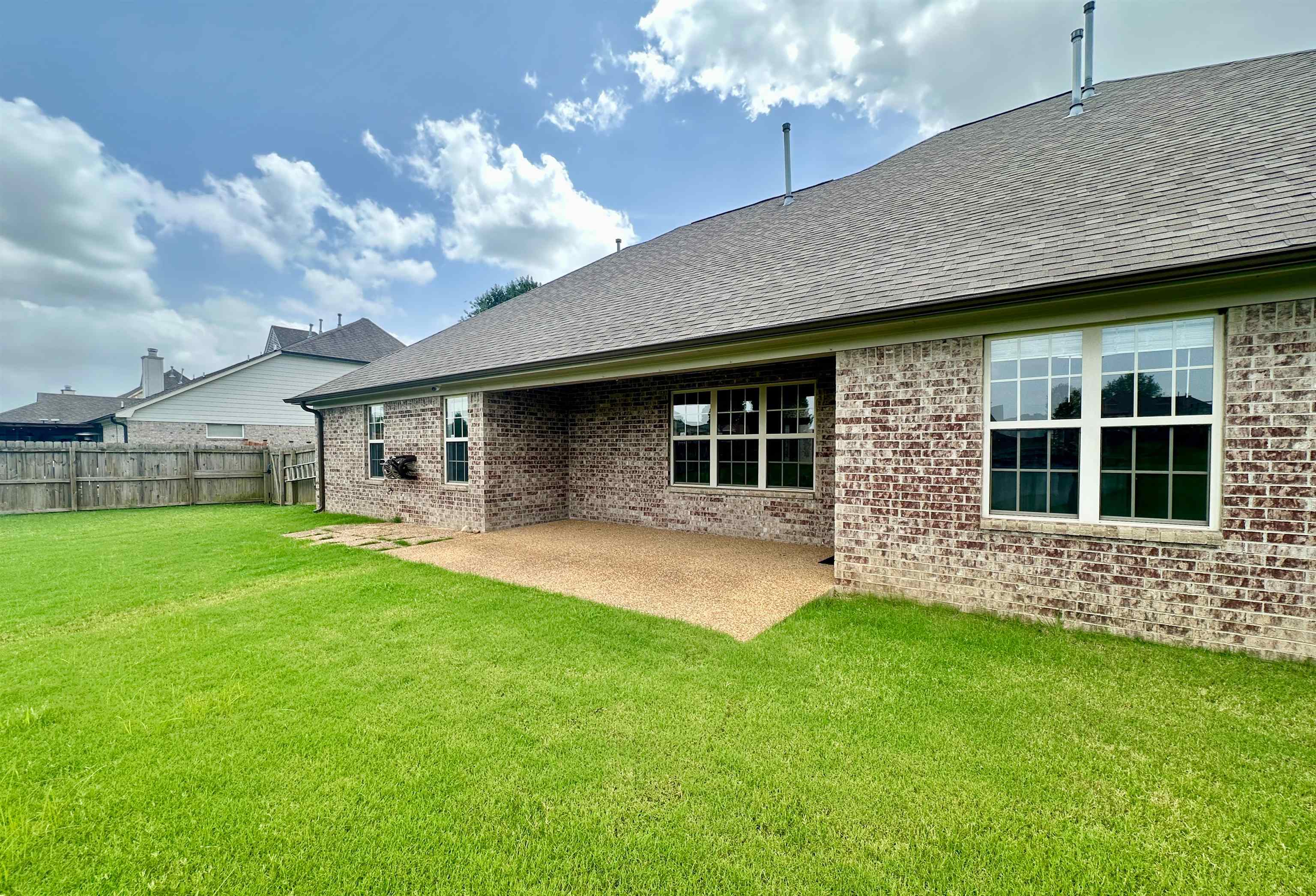 Rear view of property with a covered patio area to enjoy.