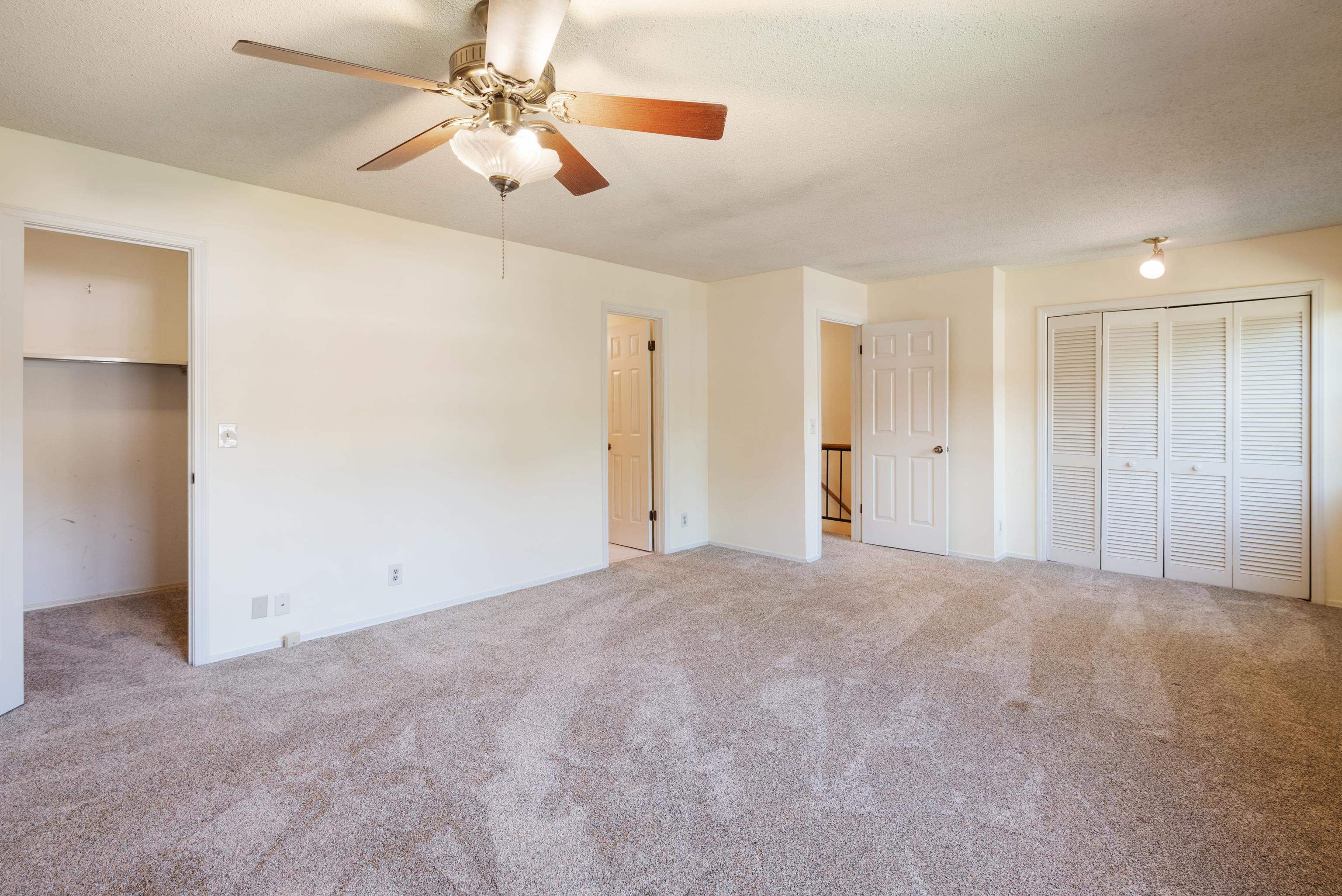 2nd bedroom featuring light colored carpet and ceiling fan