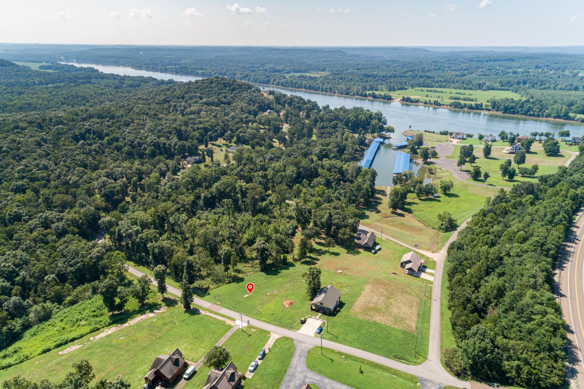 Birds eye view of property with a water view