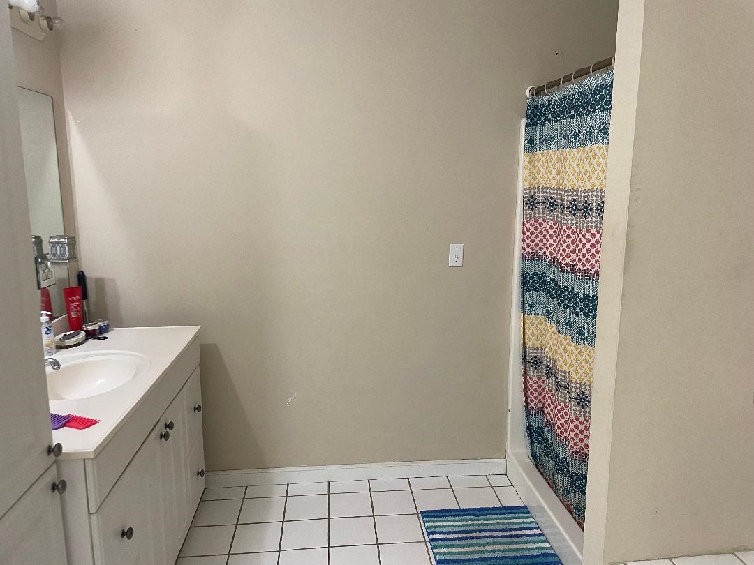 Bathroom with vanity and tile patterned flooring