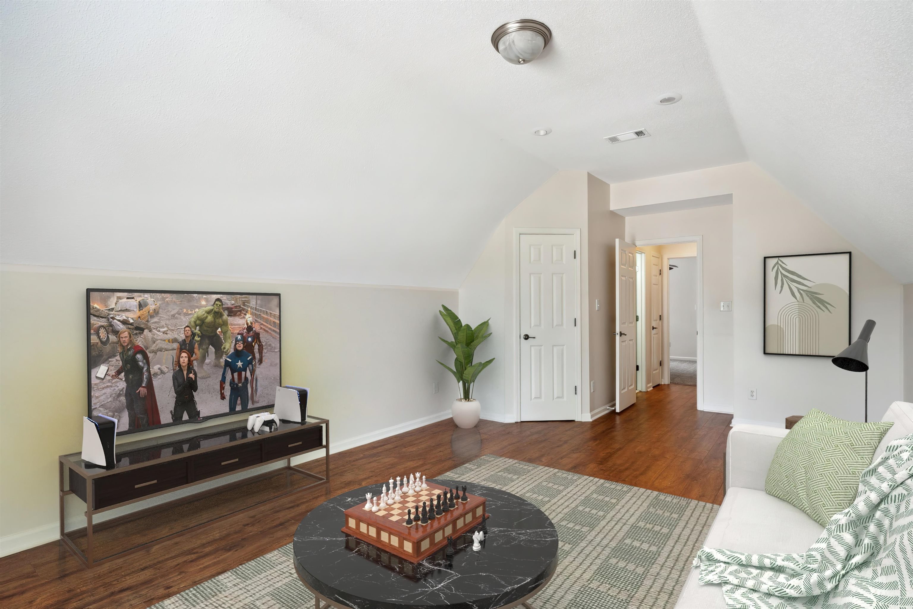 Living room with lofted ceiling and hardwood / wood-style floors