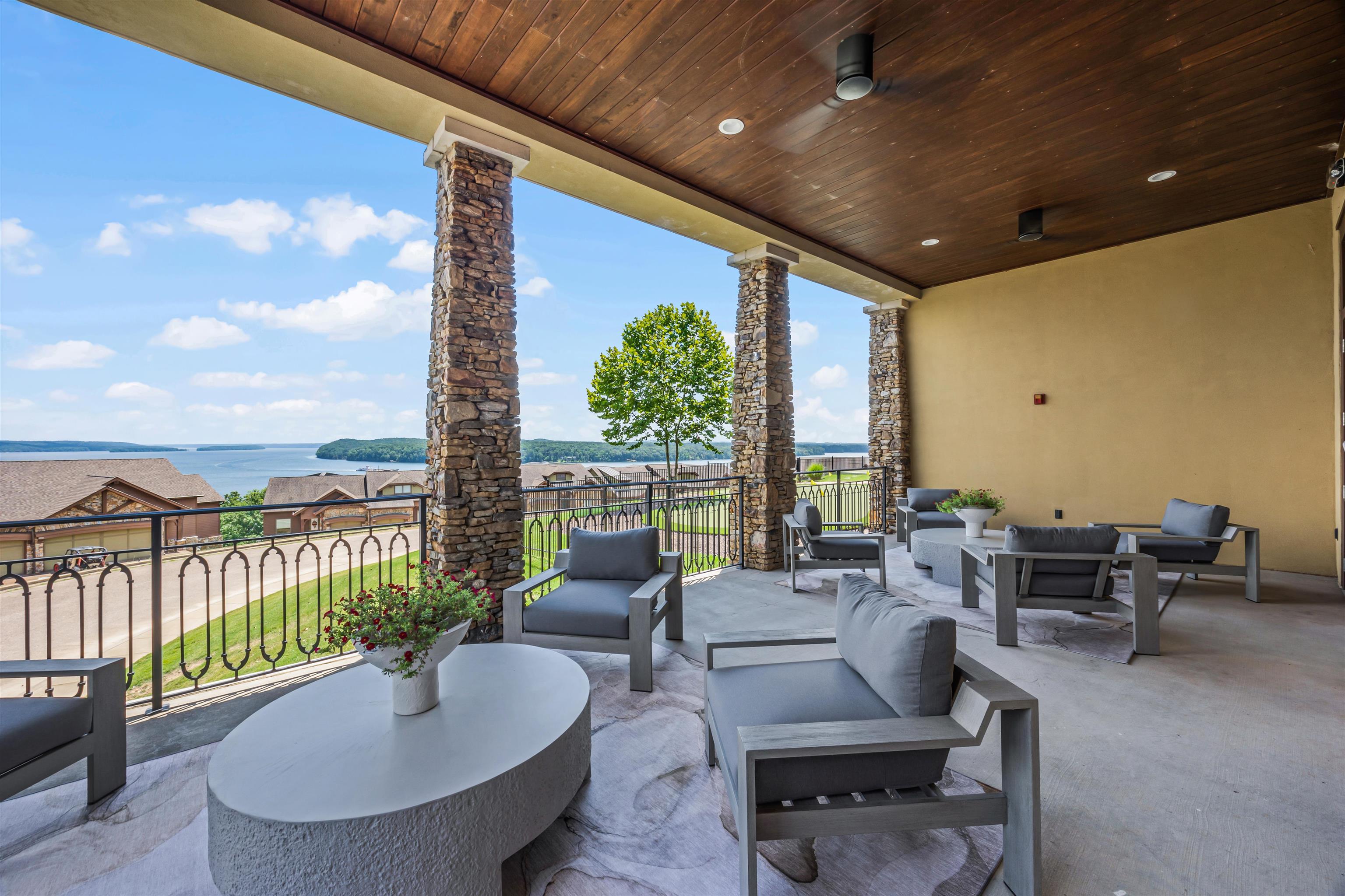 View of patio / terrace with a balcony, a water view, and an outdoor living space