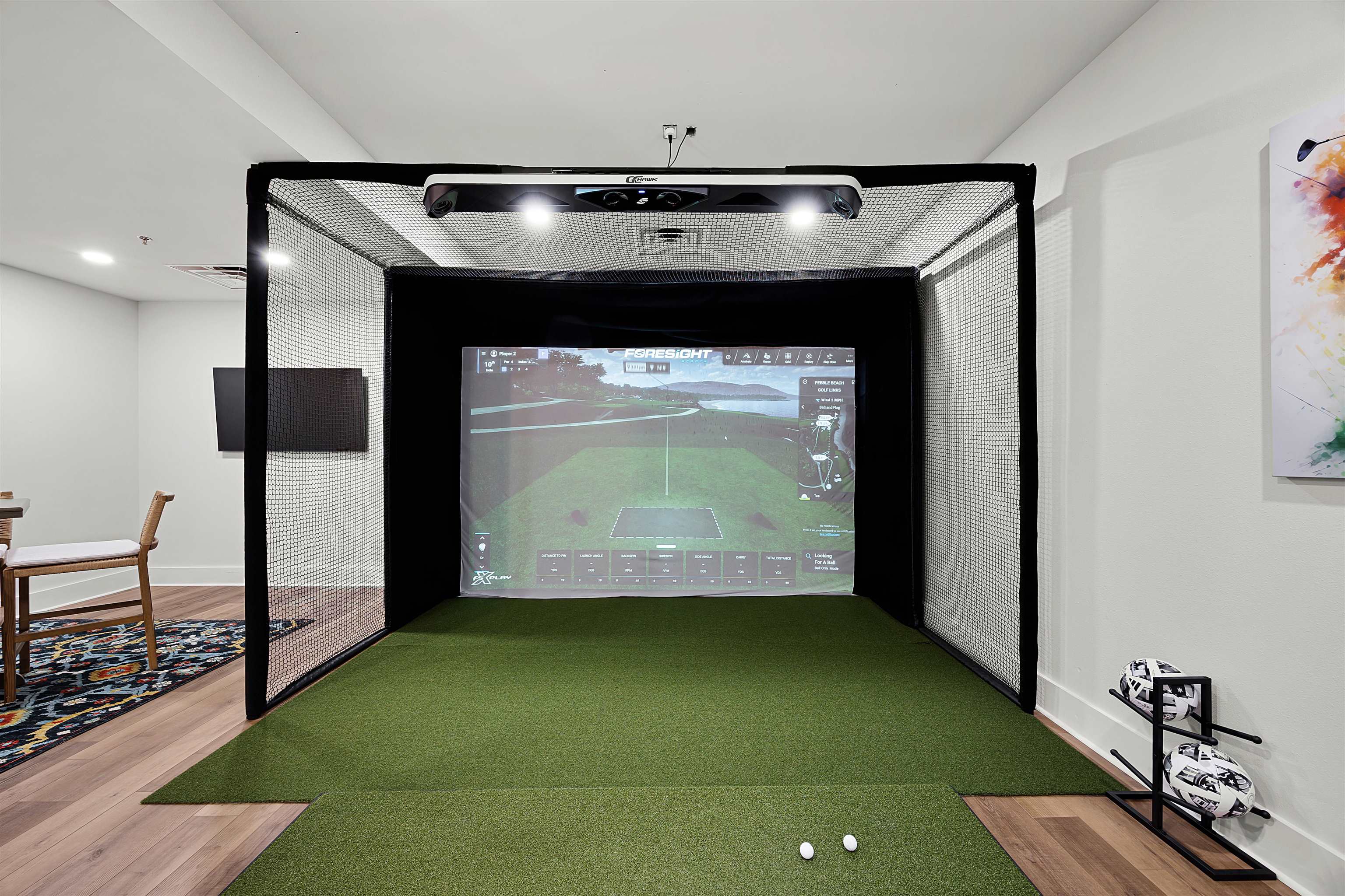 Game room featuring golf simulator and hardwood / wood-style flooring