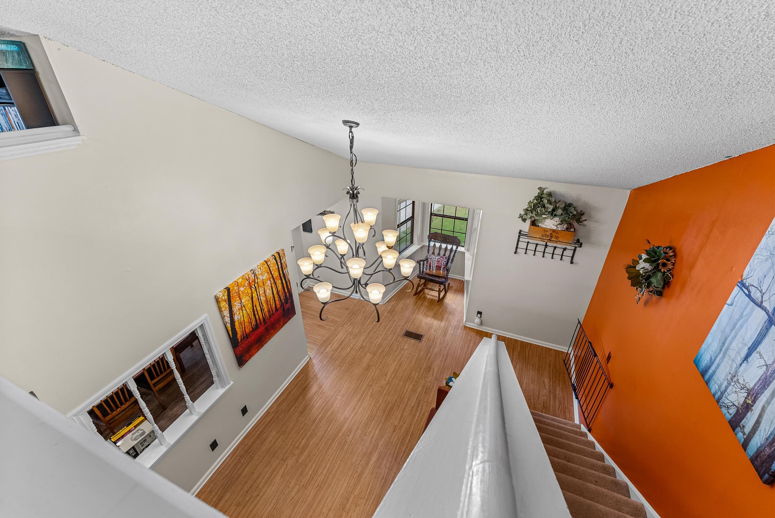 Living room featuring a notable chandelier, hardwood / wood-style floors, and a textured ceiling