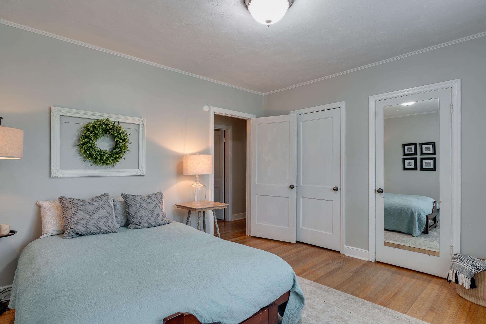 Bedroom with light wood-type flooring and ornamental molding