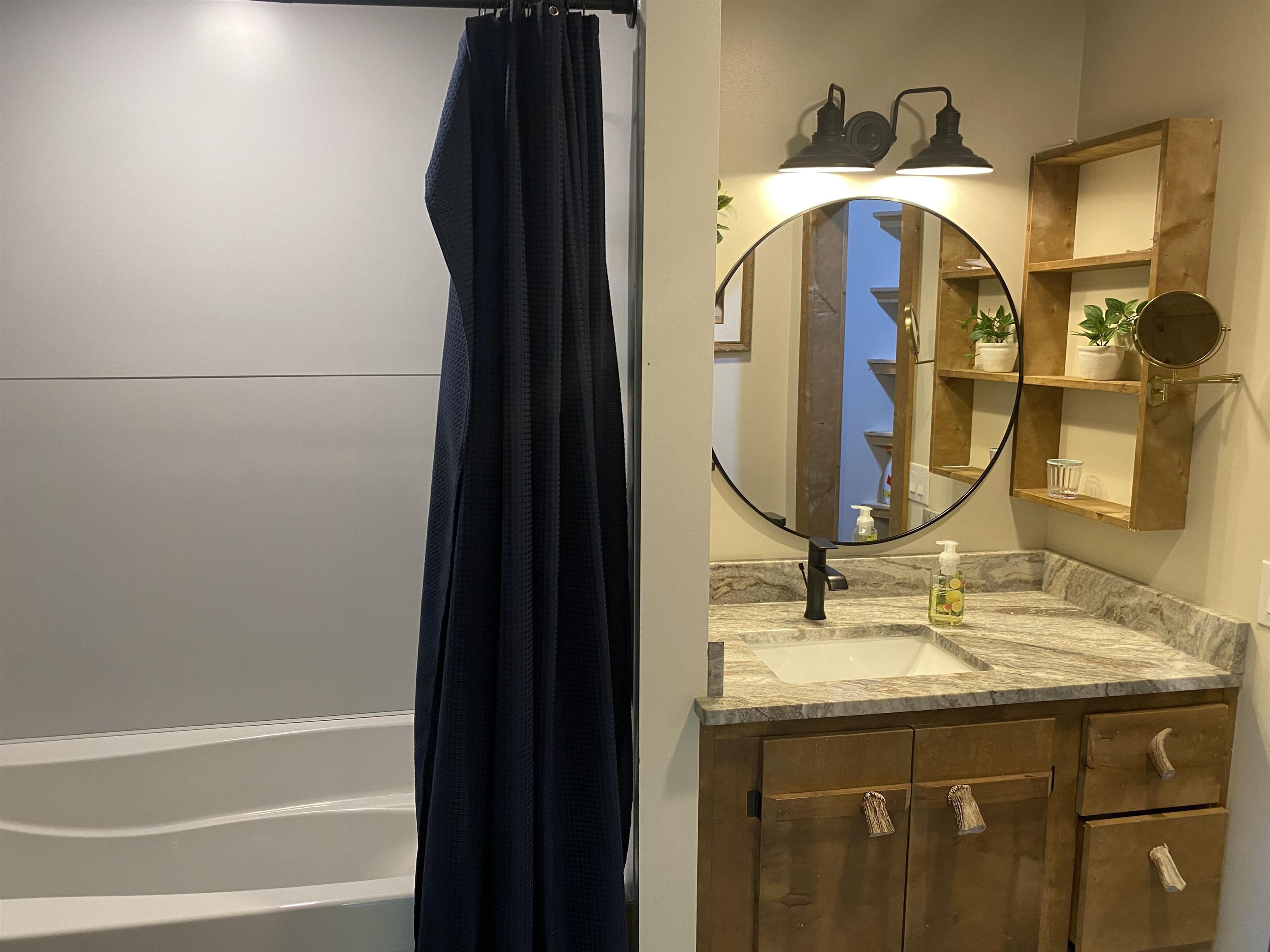 Bathroom with shower / tub combo with curtain and vanity