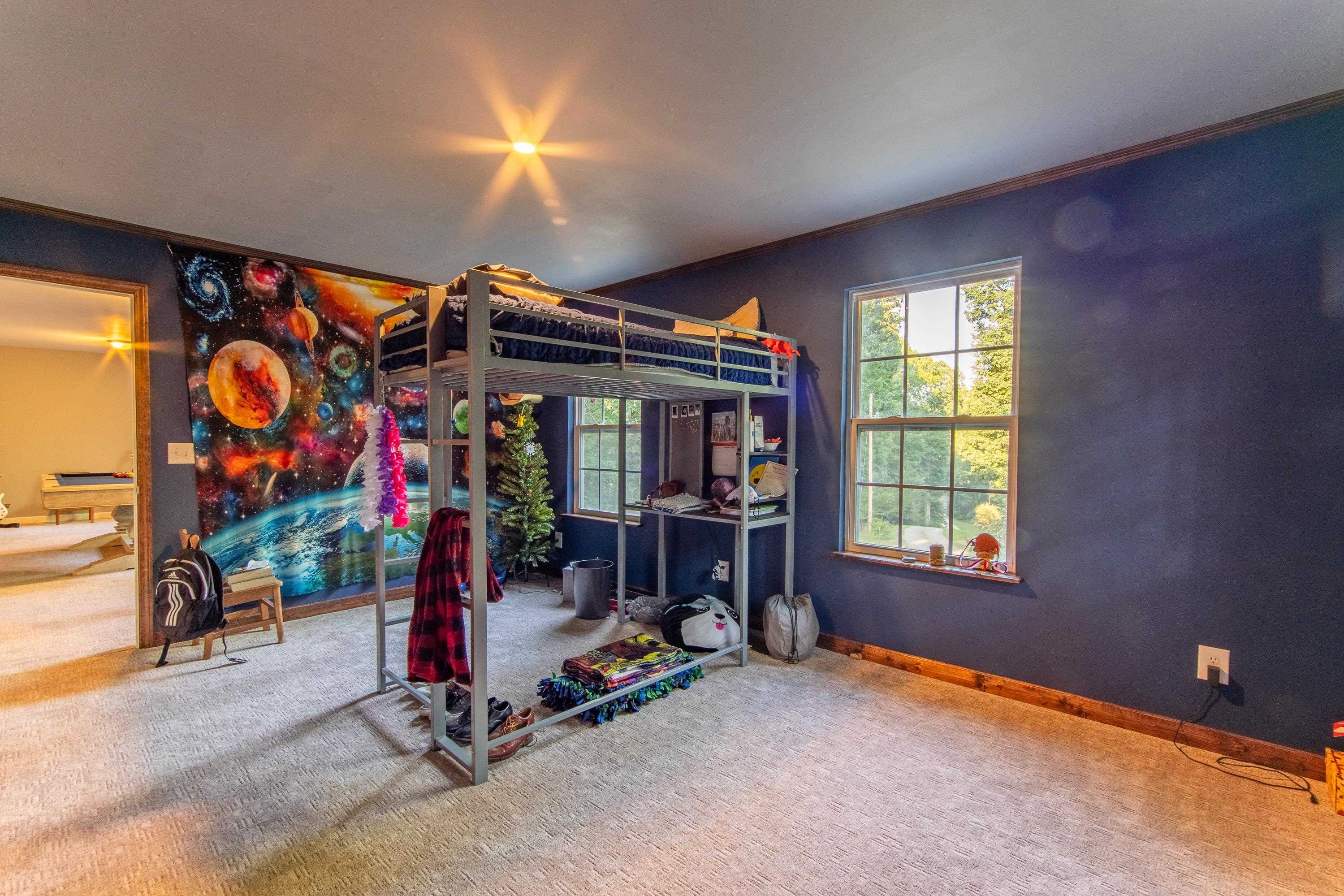 Bedroom featuring ornamental molding and carpet