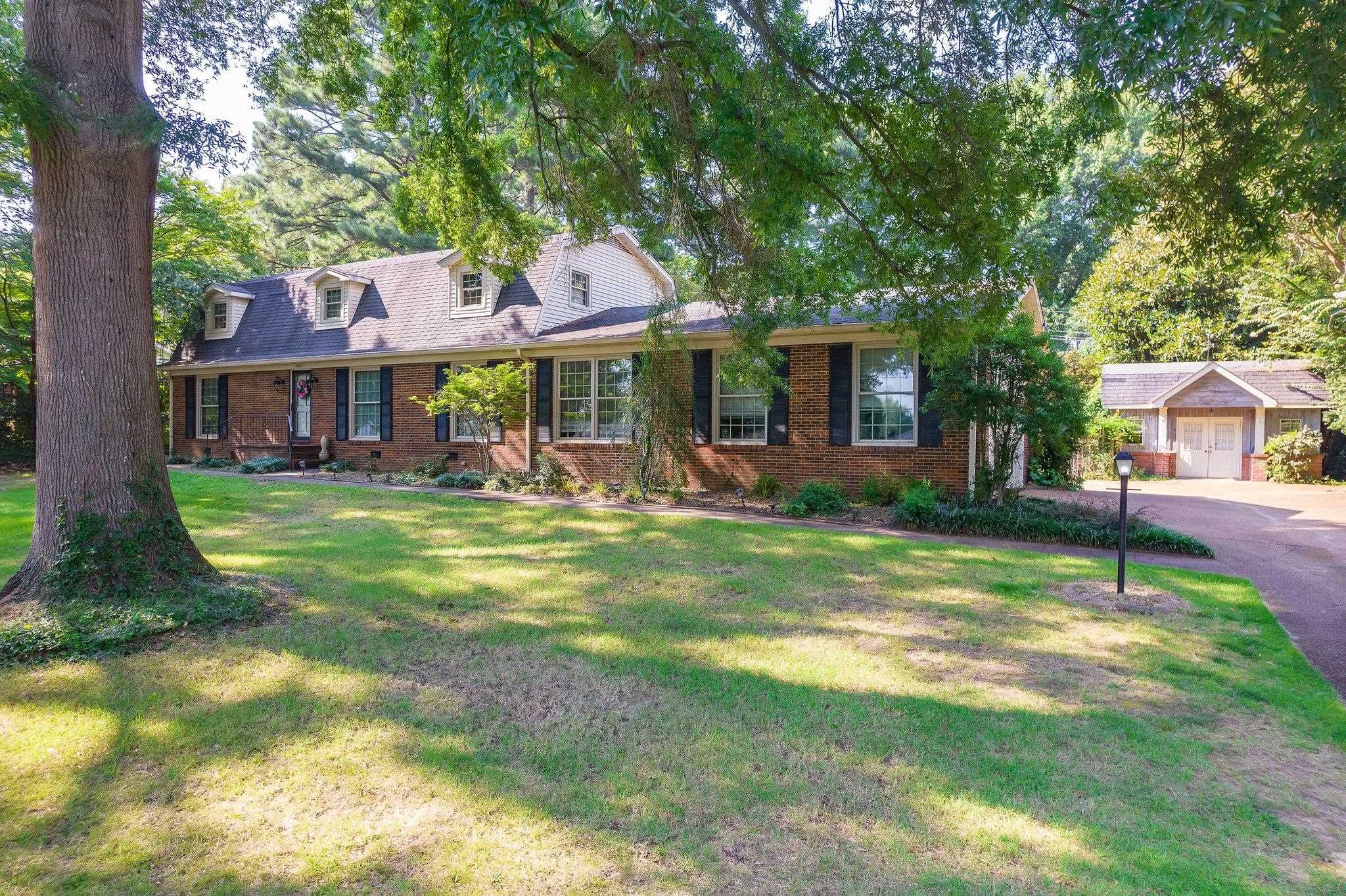 View of front of property featuring a garage and a front yard