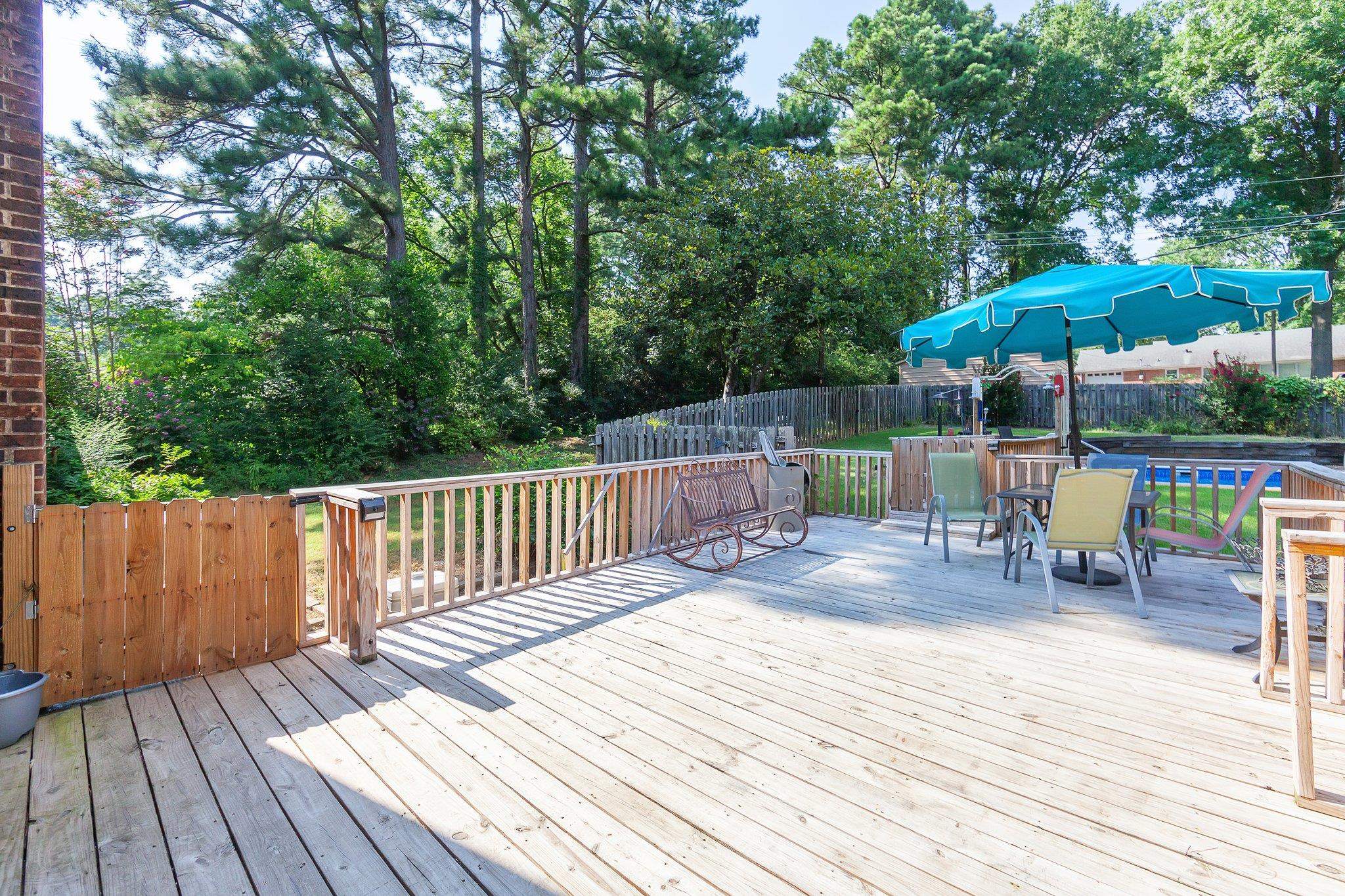 Wooden terrace featuring a swimming pool