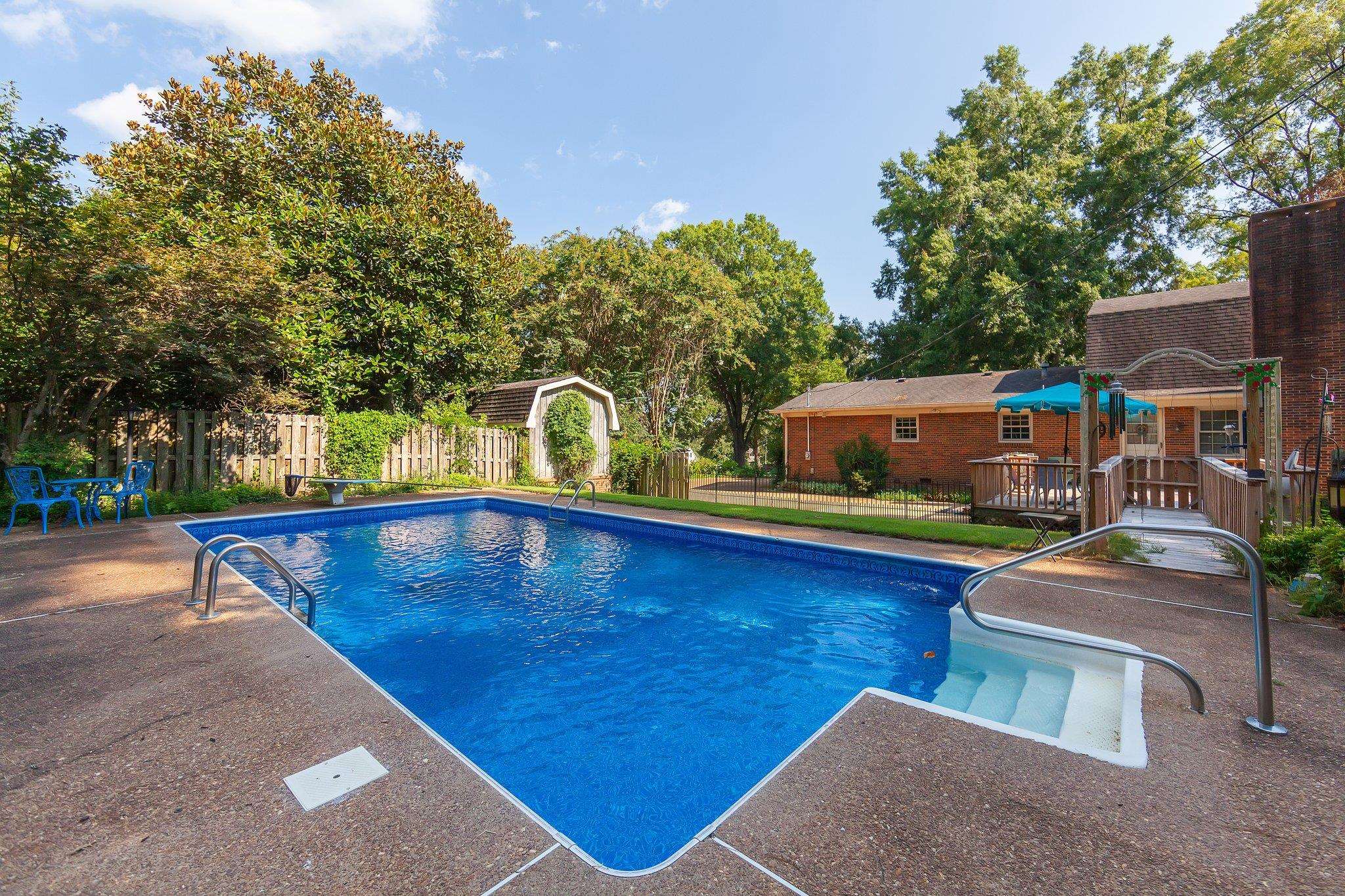 View of swimming pool with a wooden deck