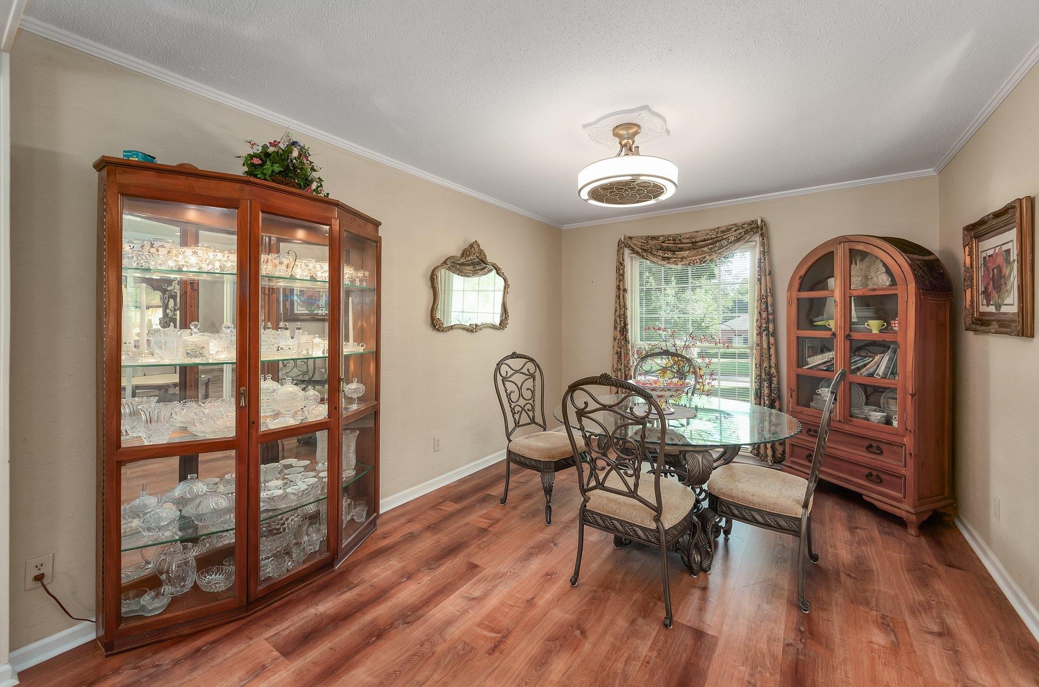 Dining room with wood-type flooring and ornamental molding