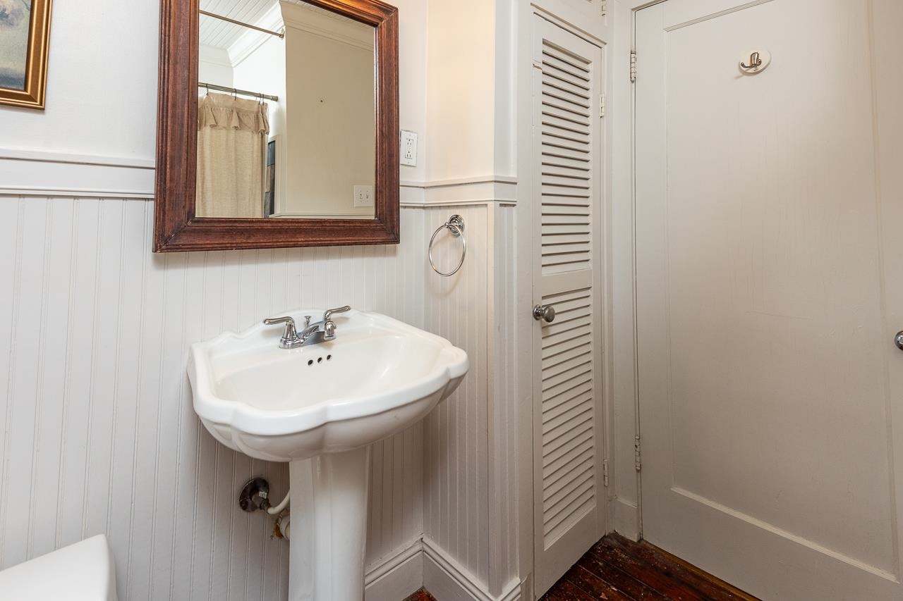 Bathroom with toilet and hardwood / wood-style floors