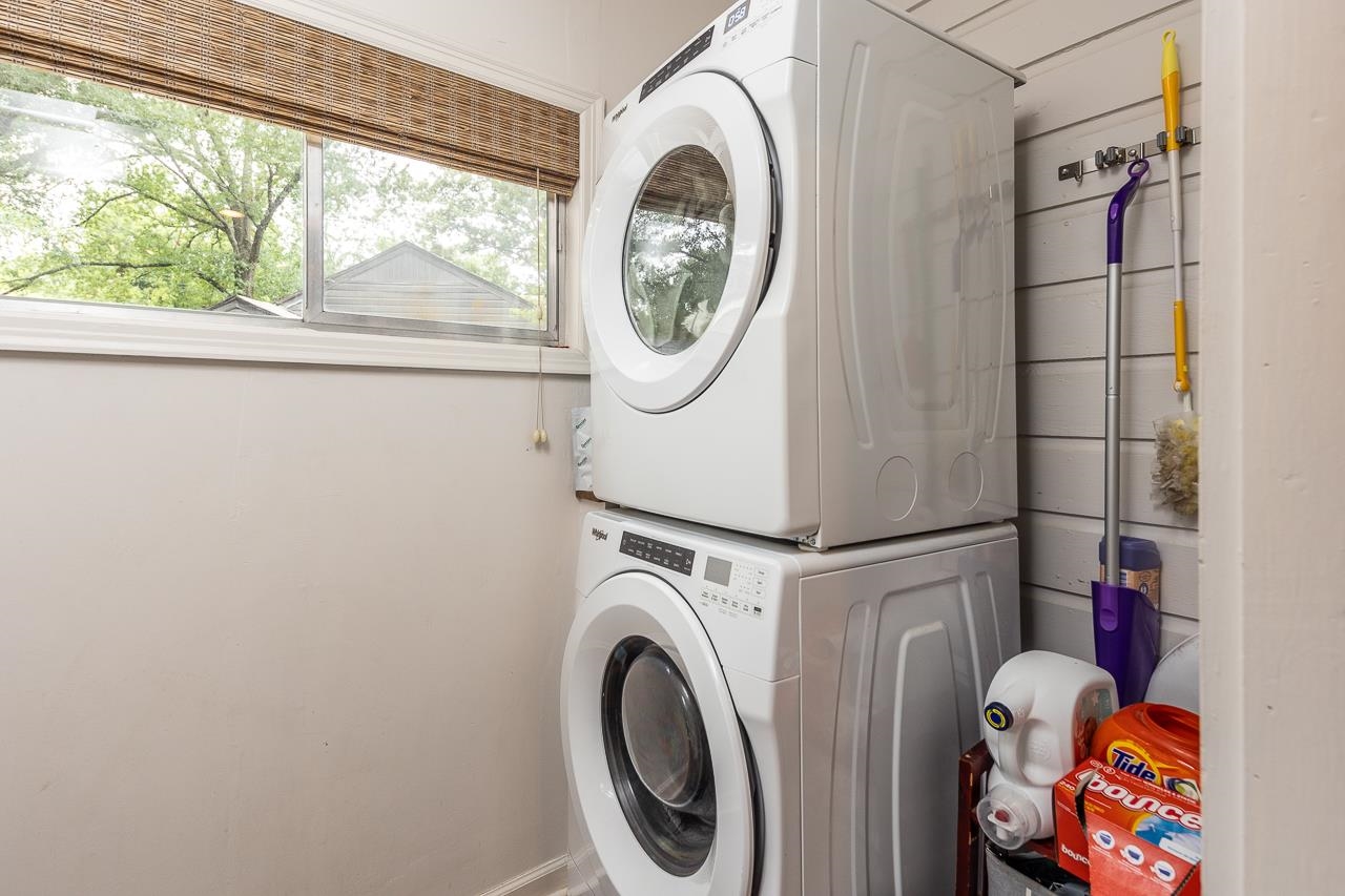 Laundry room featuring stacked washer / drying machine