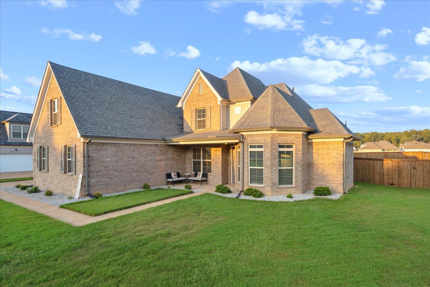 View of front of home with a garage and a front lawn