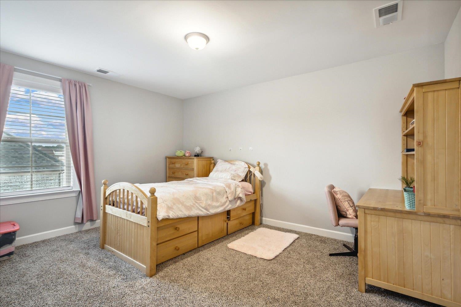 Bedroom with light colored carpet