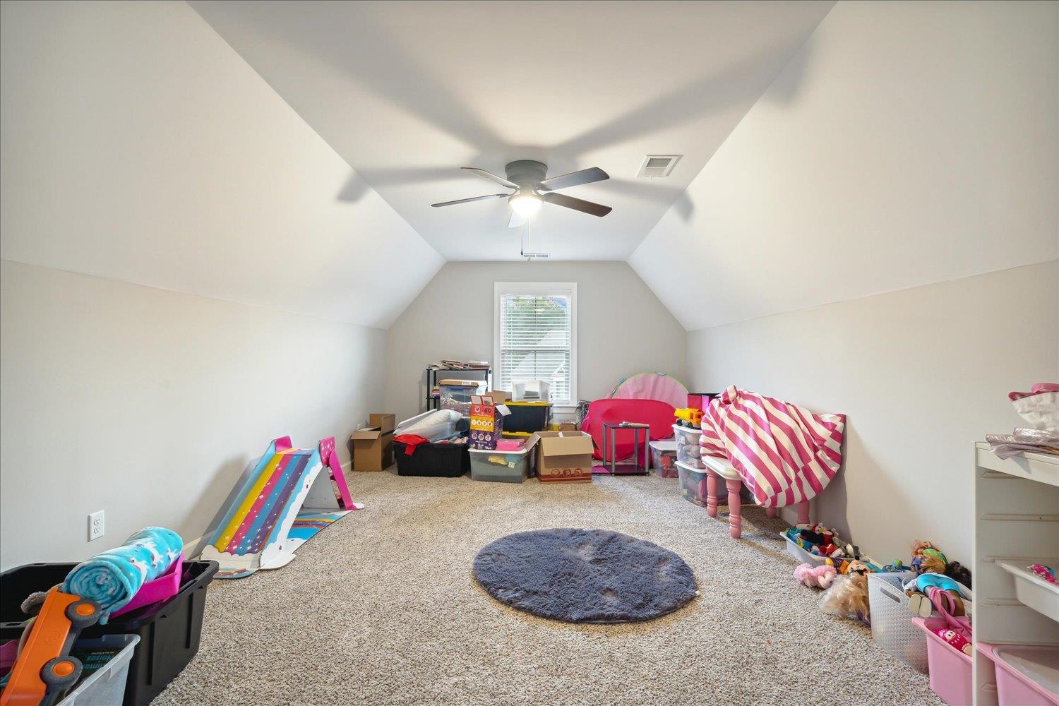 Game room featuring vaulted ceiling, carpet floors, and ceiling fan