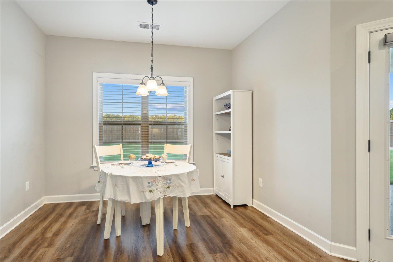 Dining space featuring a chandelier and hardwood / wood-style floors