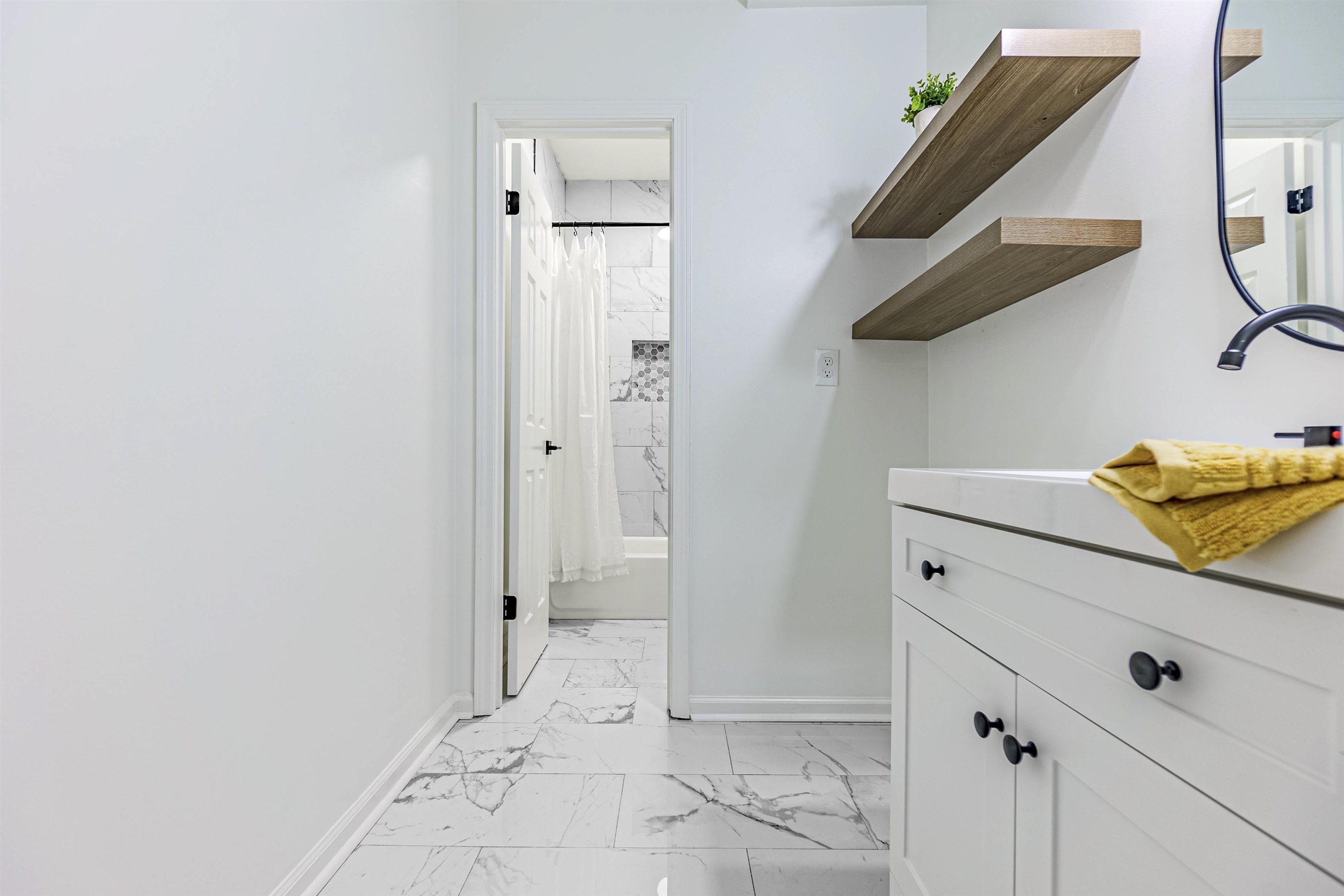 Bathroom with shower / tub combo with curtain, vanity, and tile patterned floors