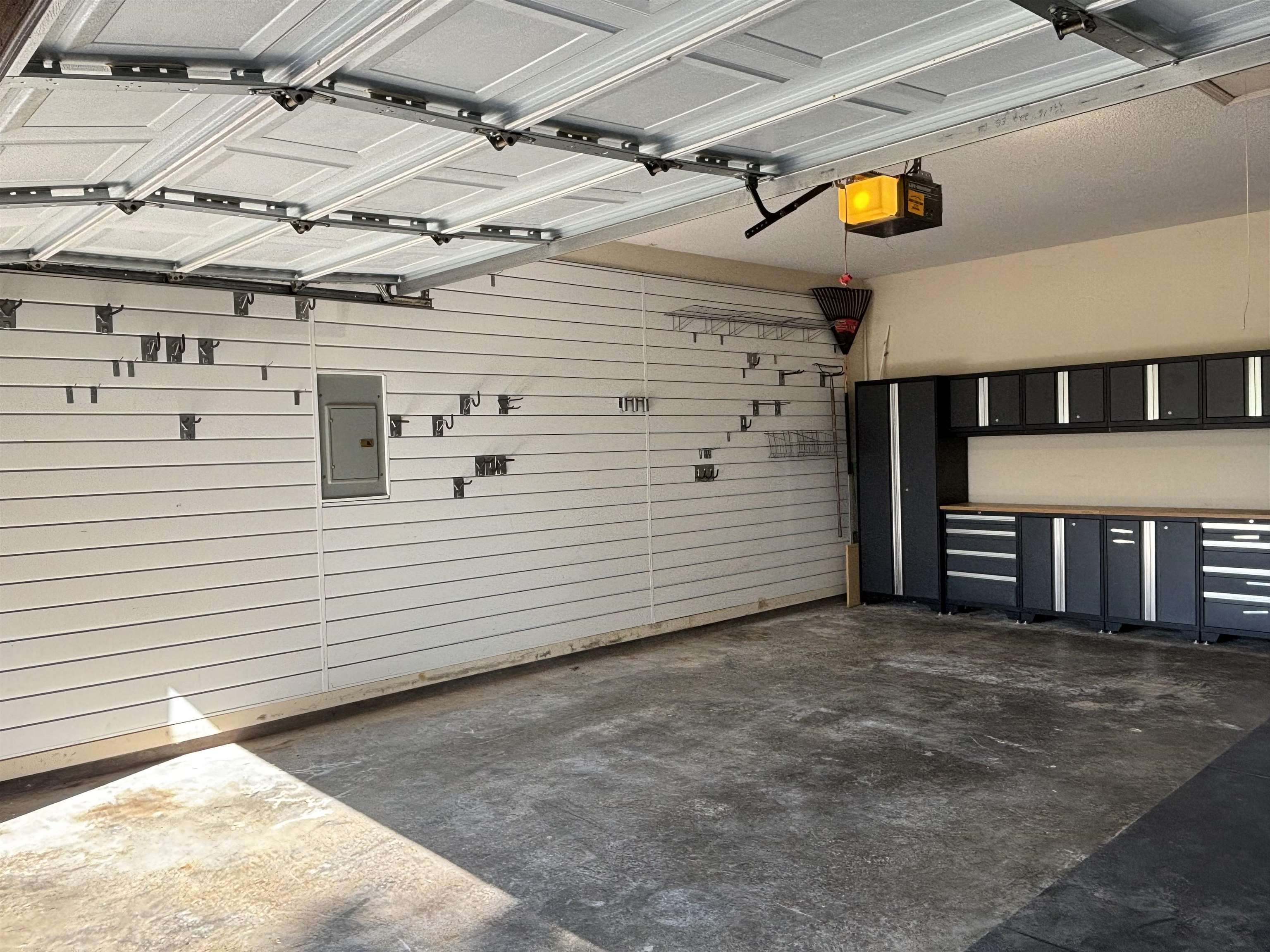 Garage with a garage door opener and electric panel